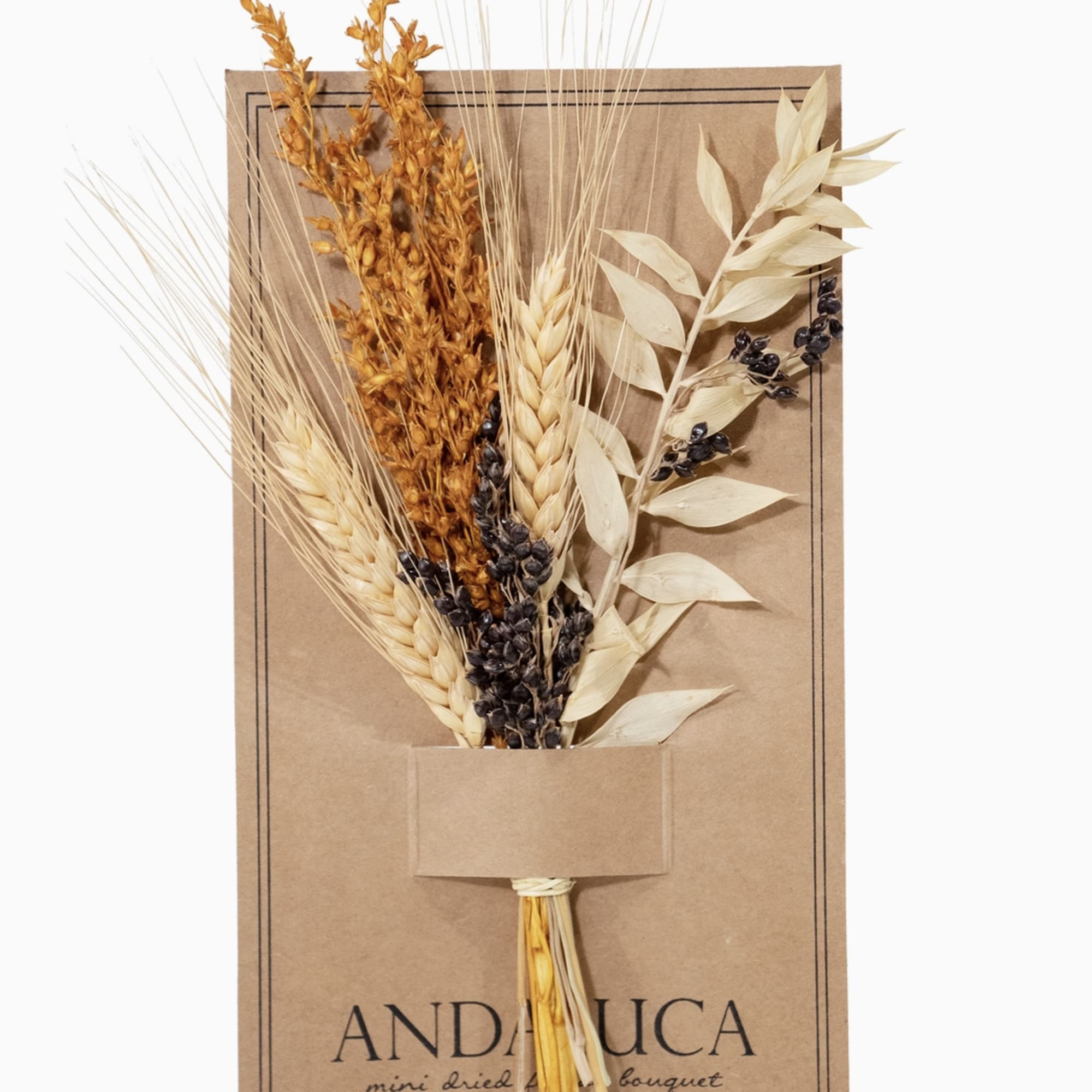 Dried bouquet of wheat and seed stems on a kraft paper card