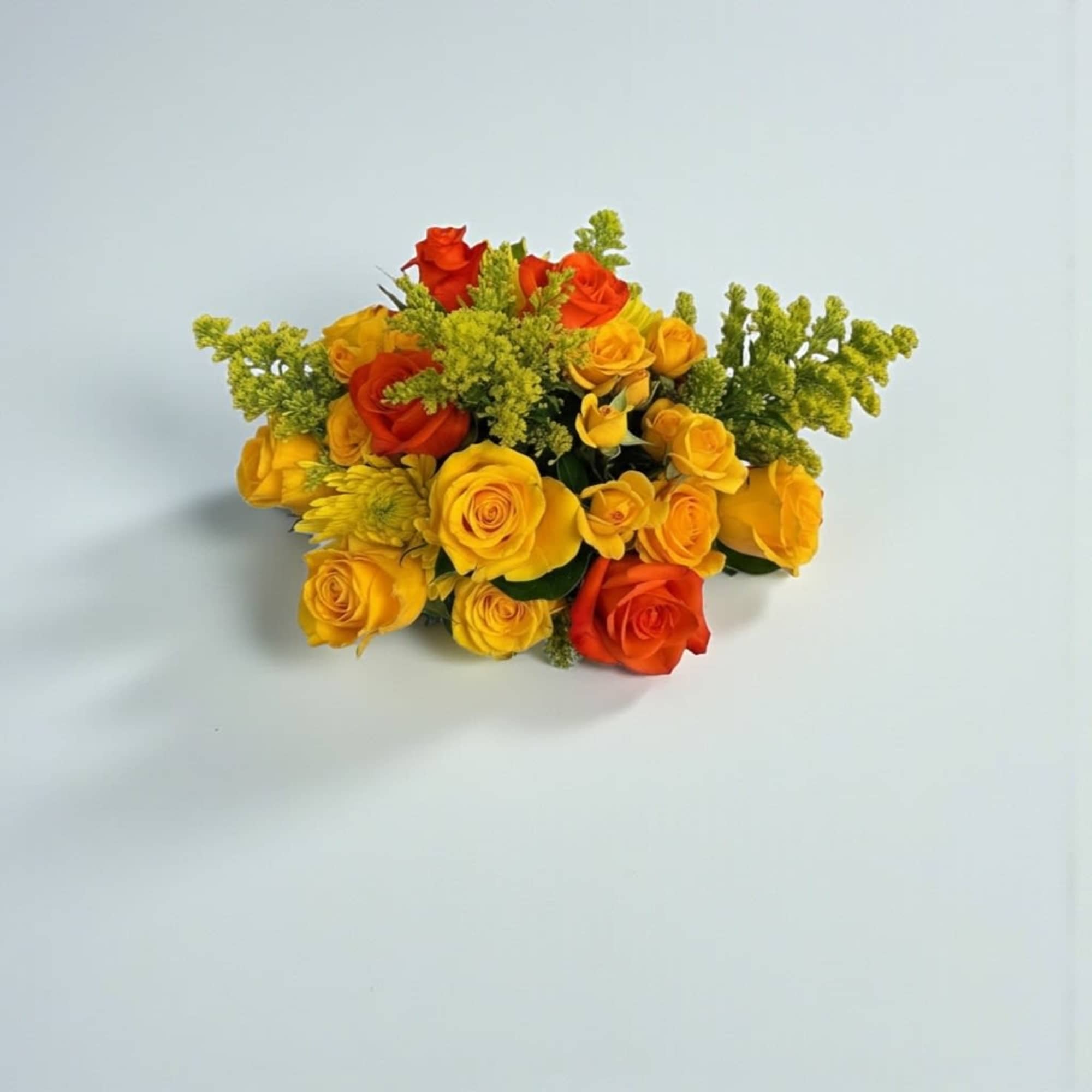 Bouquet of yellow and orange roses with green filler
