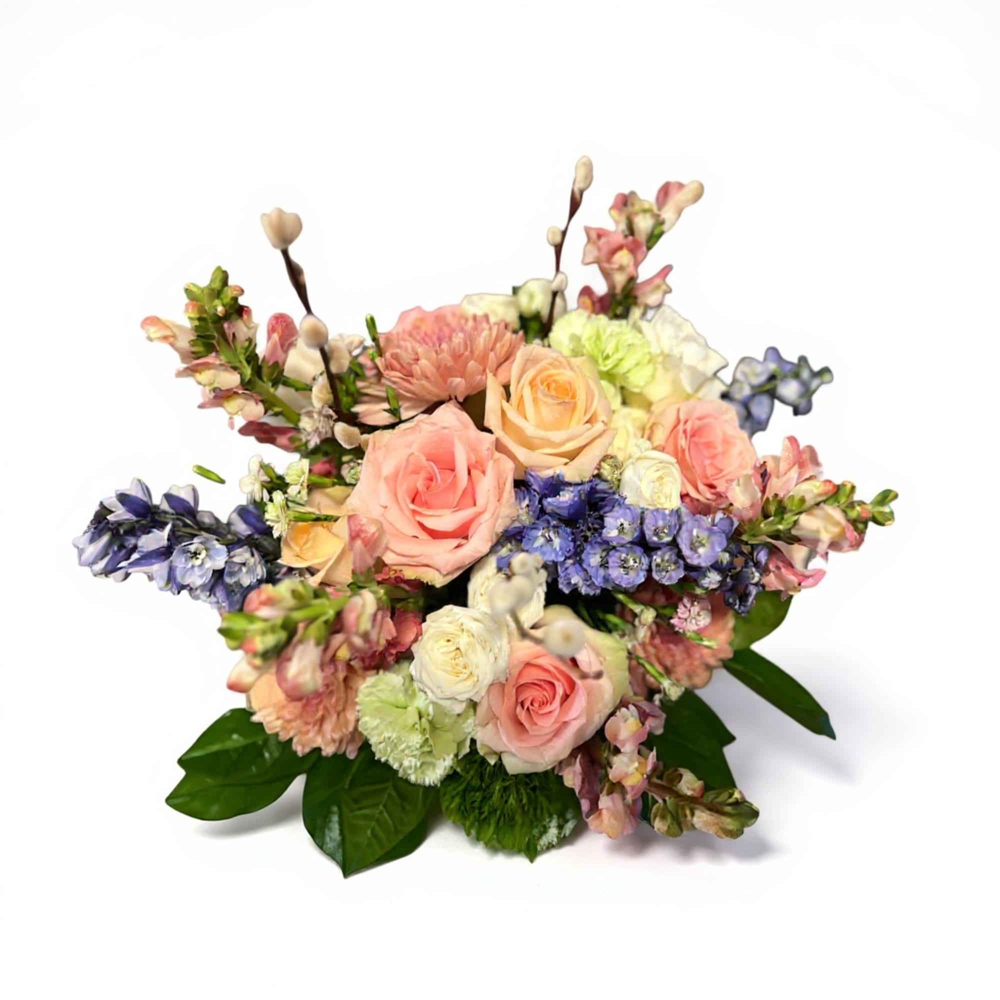 Mixed bouquet of pastel roses, snapdragons, and blue flowers