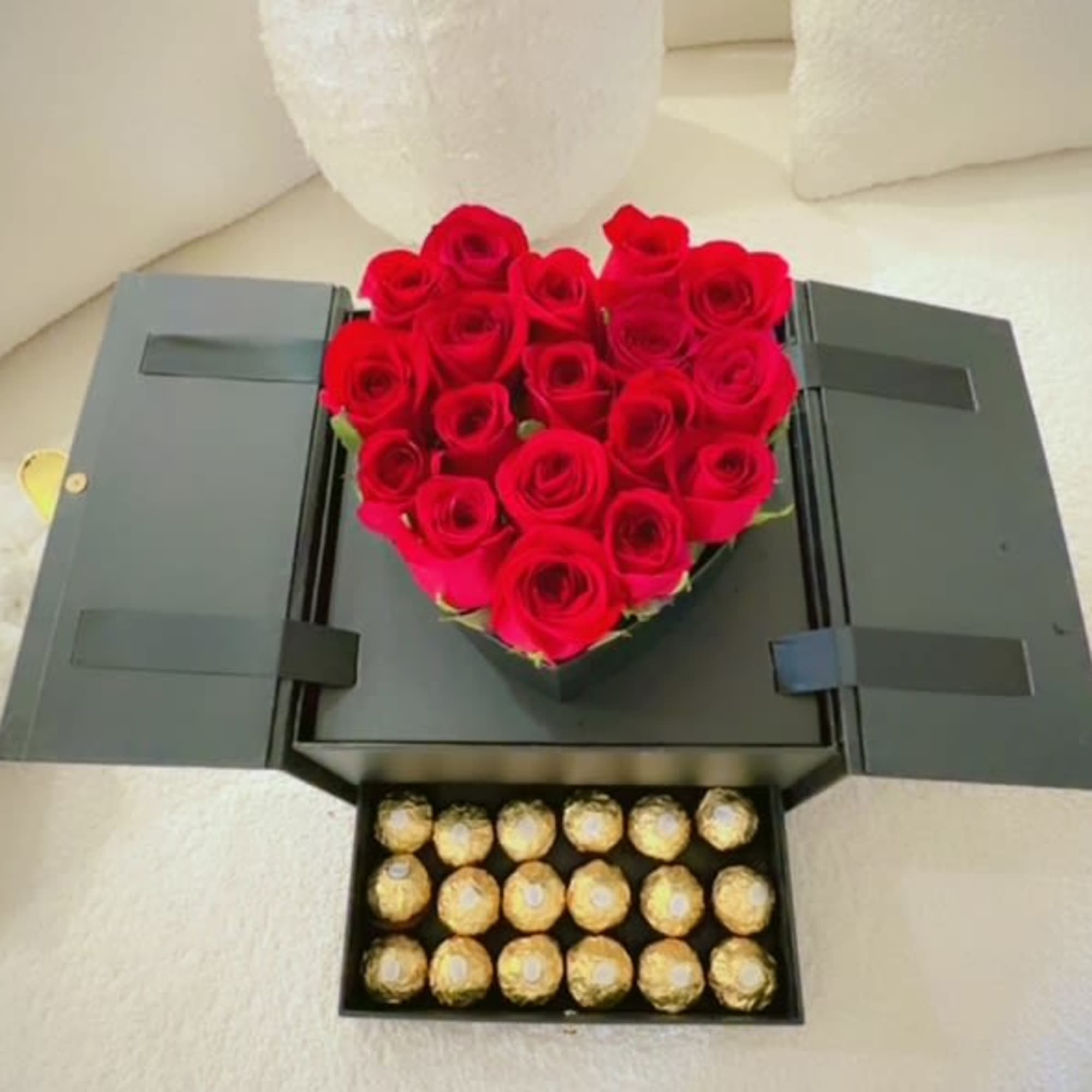 Heart-shaped red rose box with a tray of Ferrero Rocher chocolates