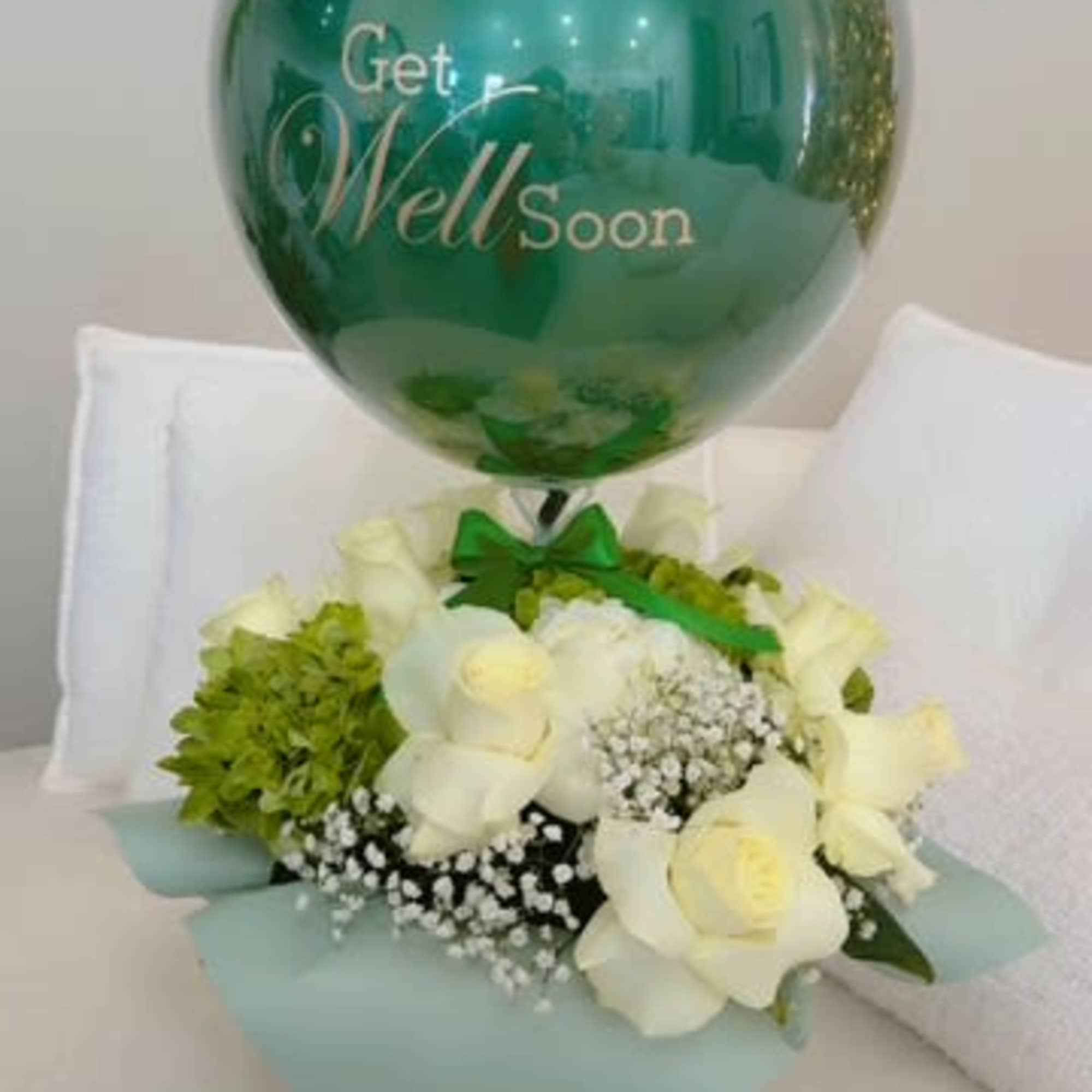 White roses and green hydrangea with a teal get well soon balloon