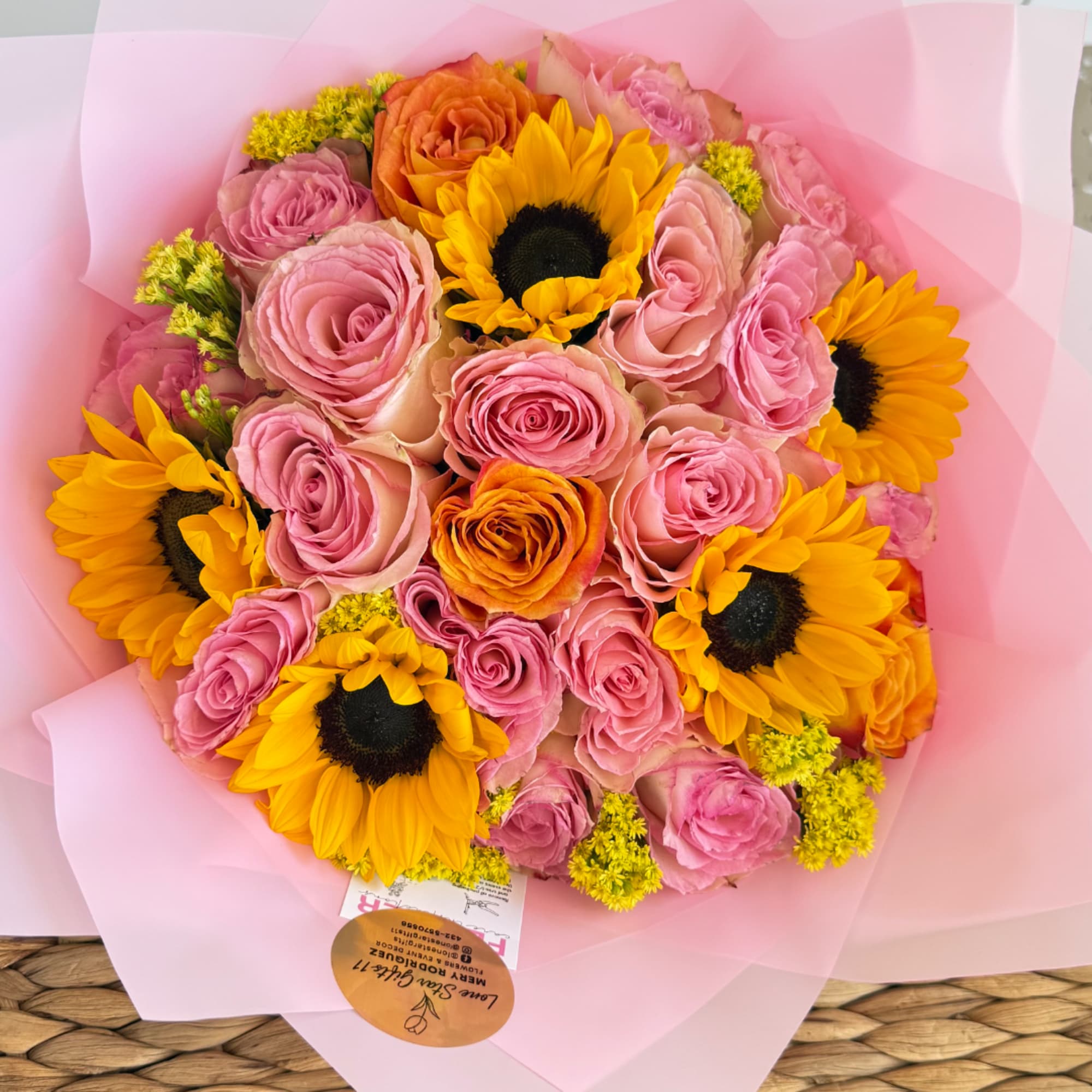 Pink rose bouquet with sunflowers wrapped in pale pink paper