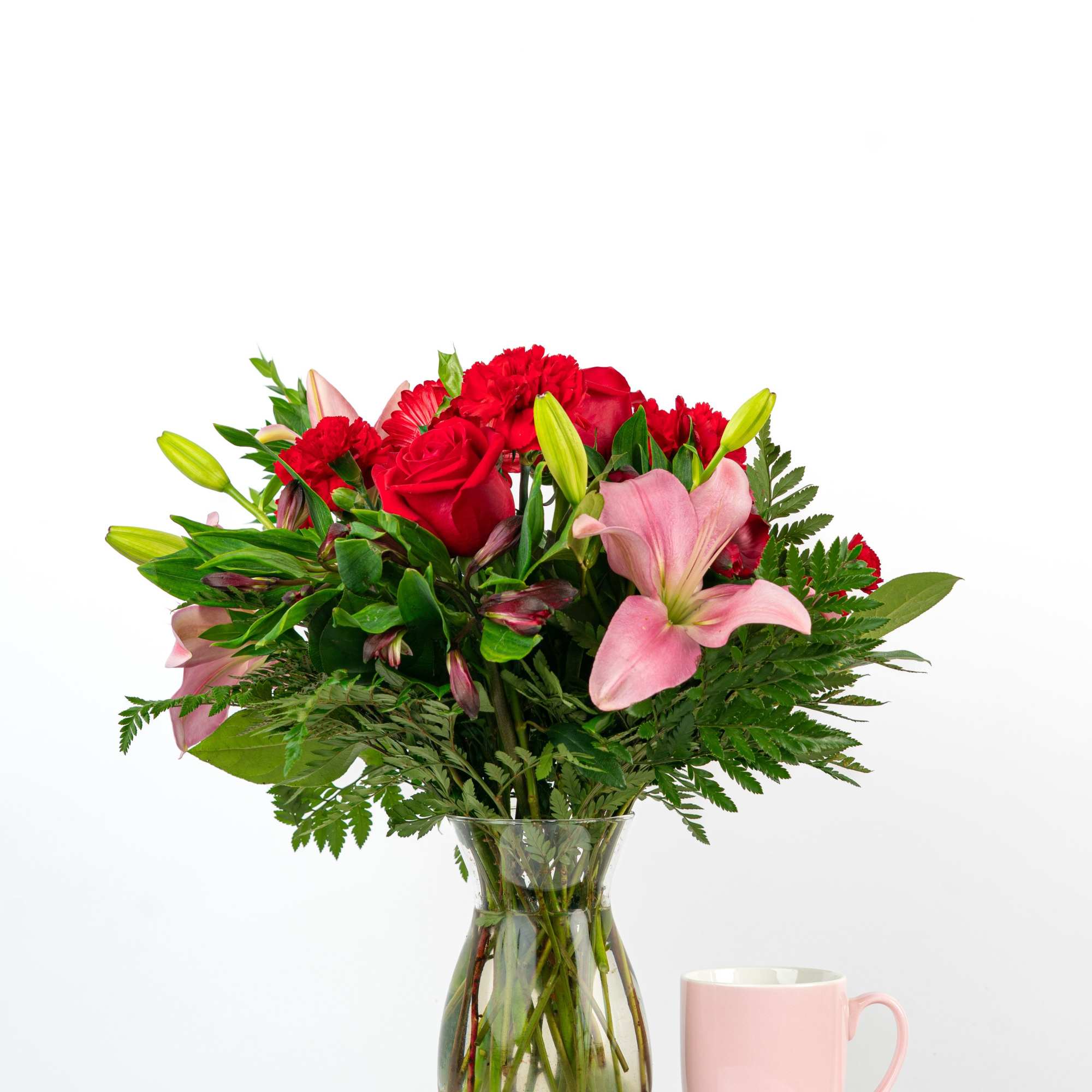 Bouquet of red roses, pink lilies, and red carnations in a glass vase, photo 2 of 3