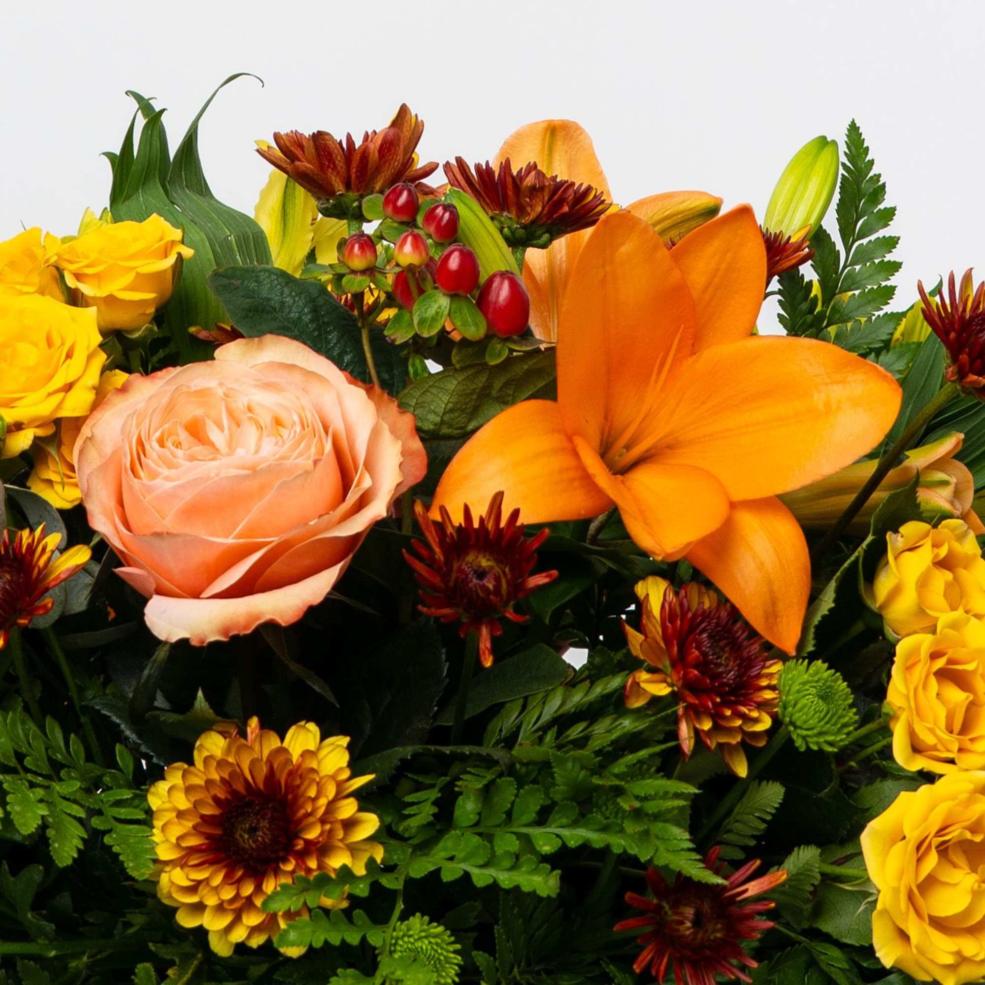 Mixed bouquet with orange lily, peach rose, and yellow roses