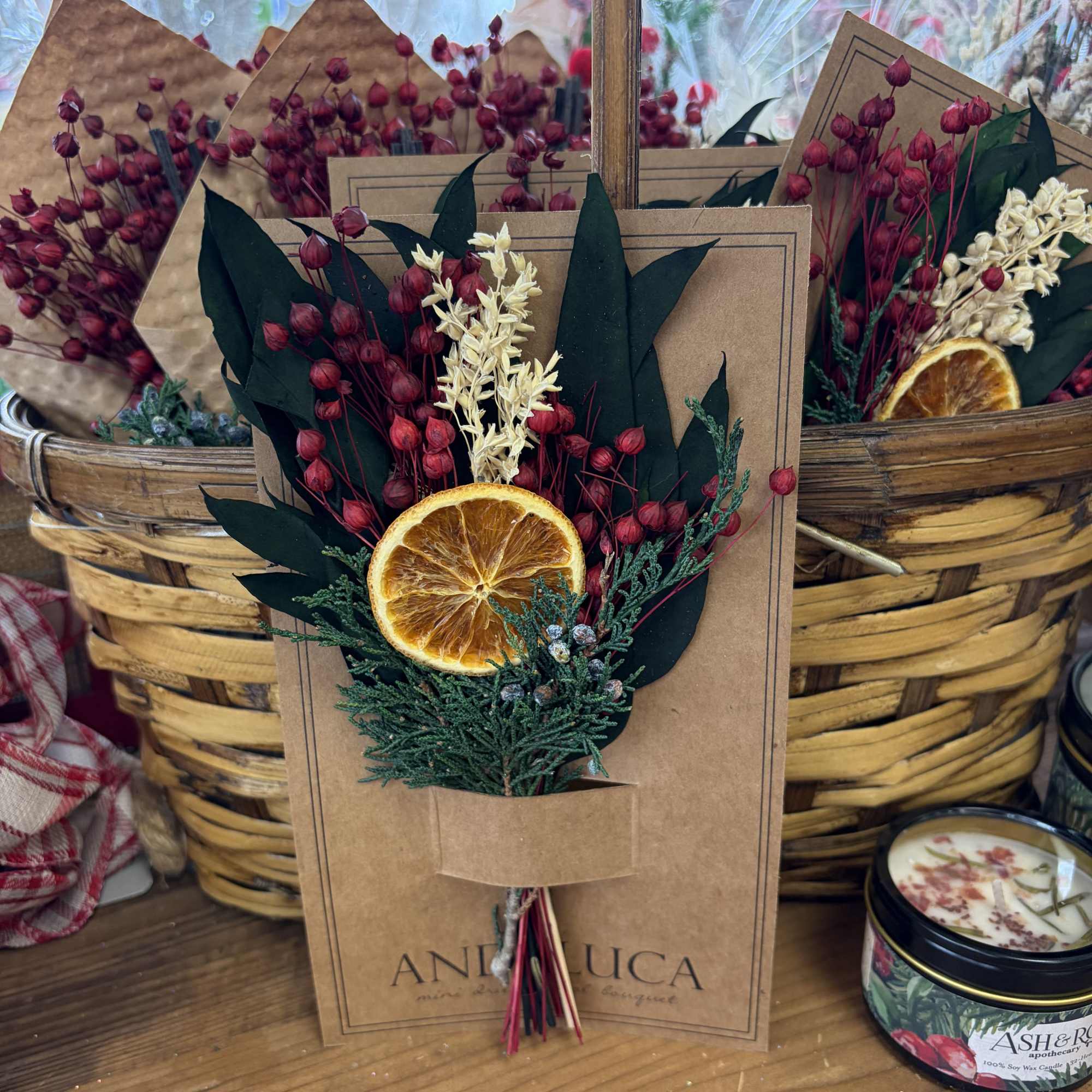 Dried floral bouquet with orange slice in kraft paper