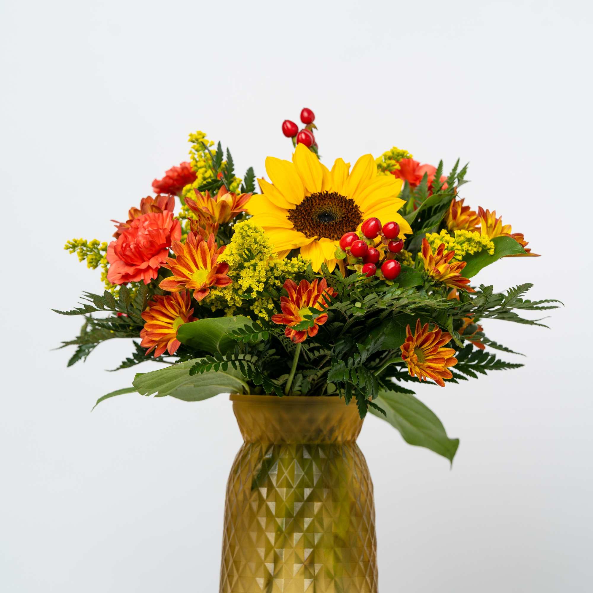 Sunflower and autumn flower arrangement in a gold vase