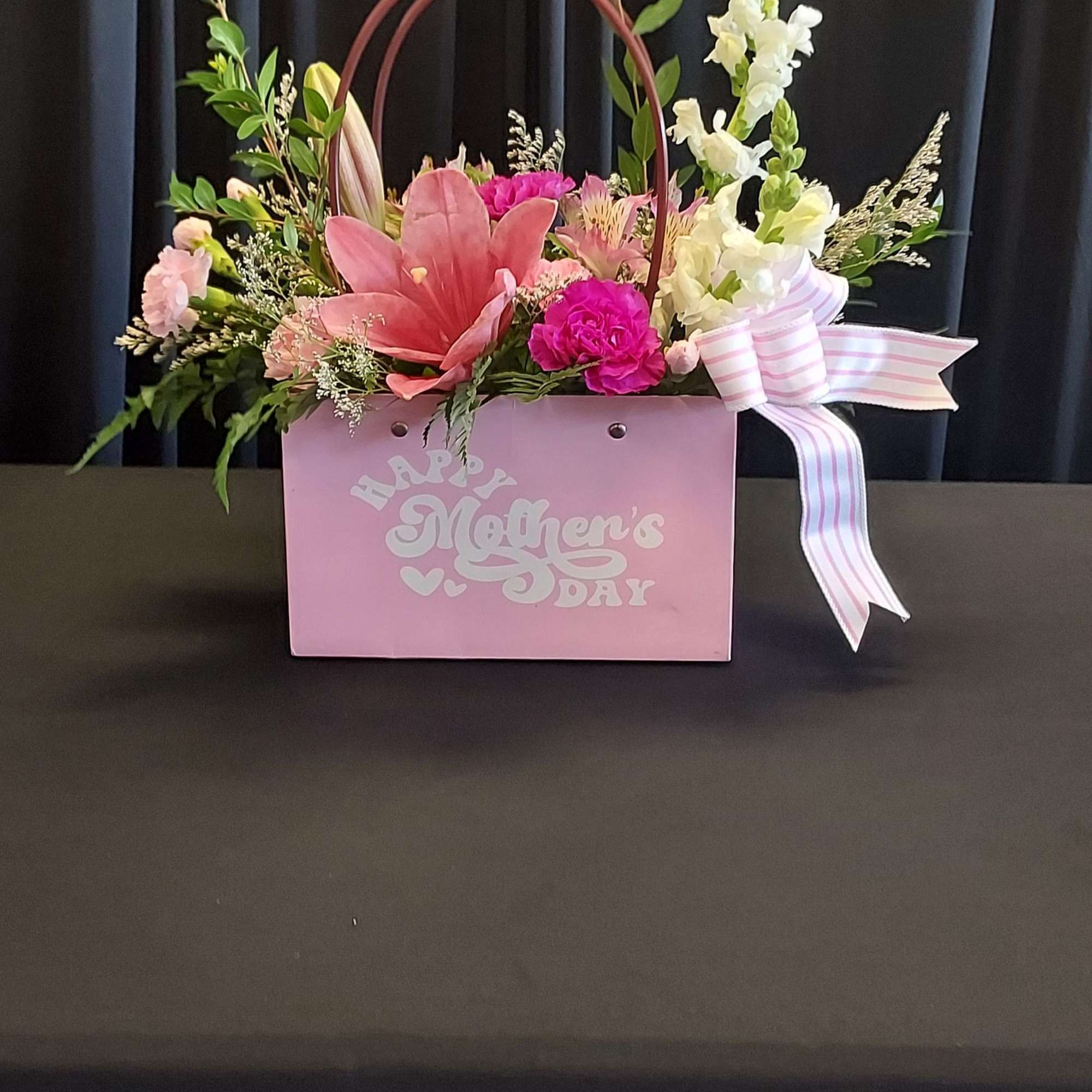 A bright pink lily takes center stage in this feminine Mother's Day