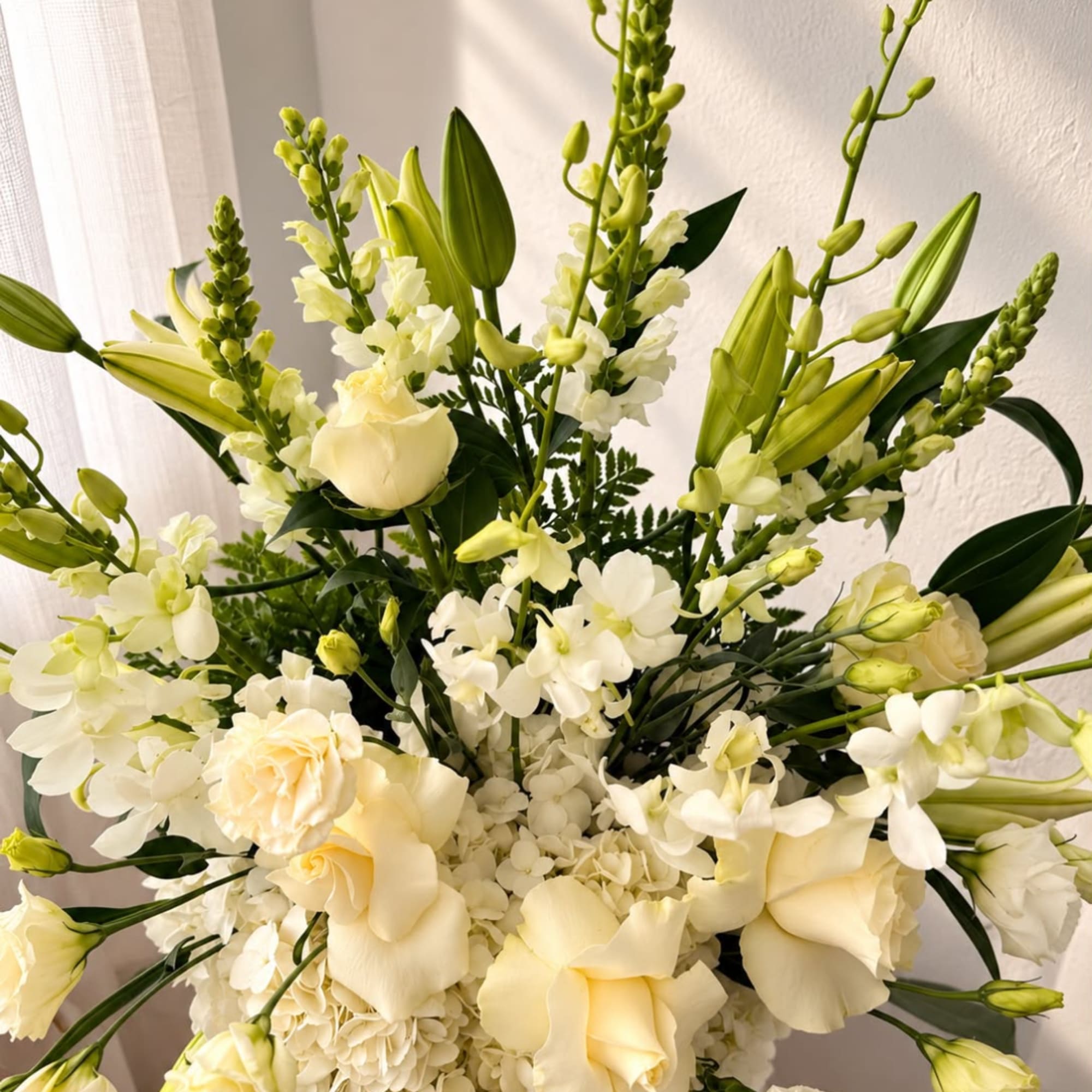 White and cream floral arrangement with roses, lilies, and orchids, photo 2 of 4