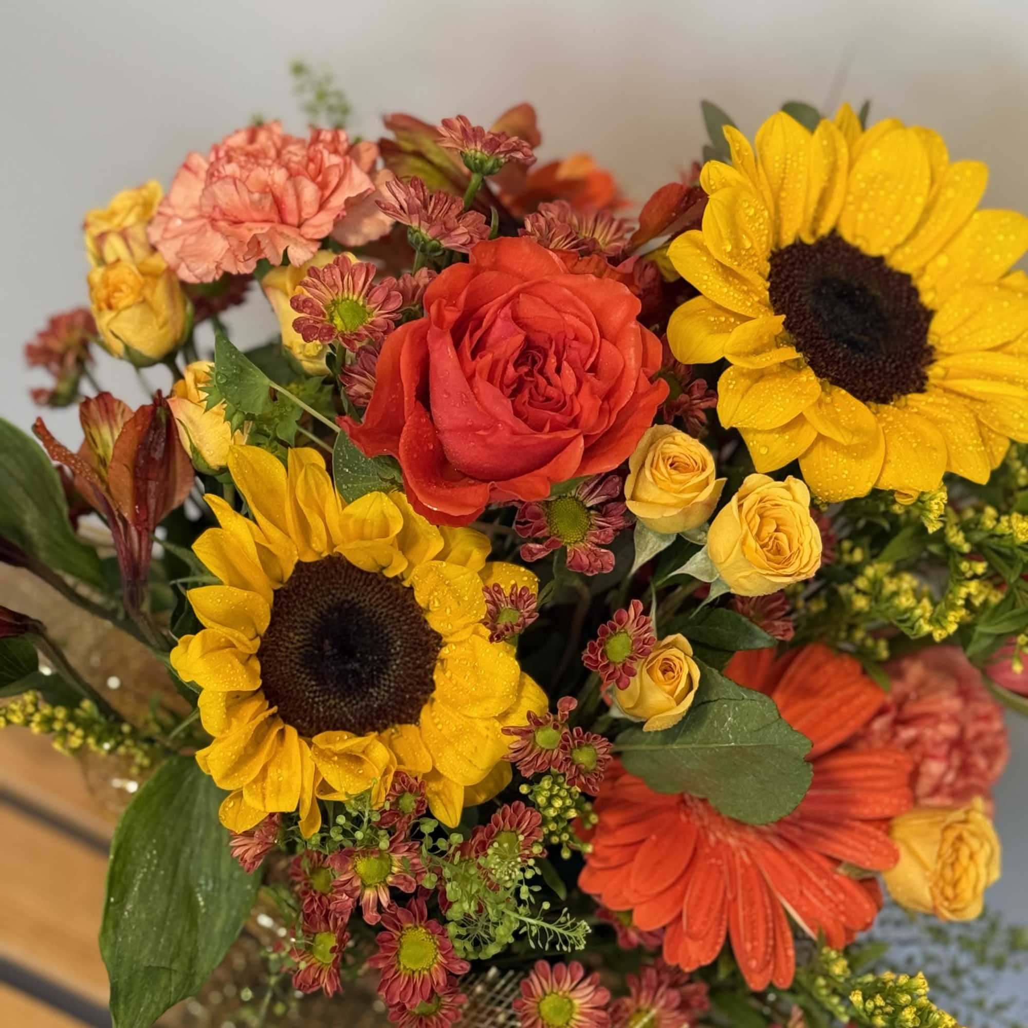 Bouquet with sunflowers, red roses, and orange gerbera daisies