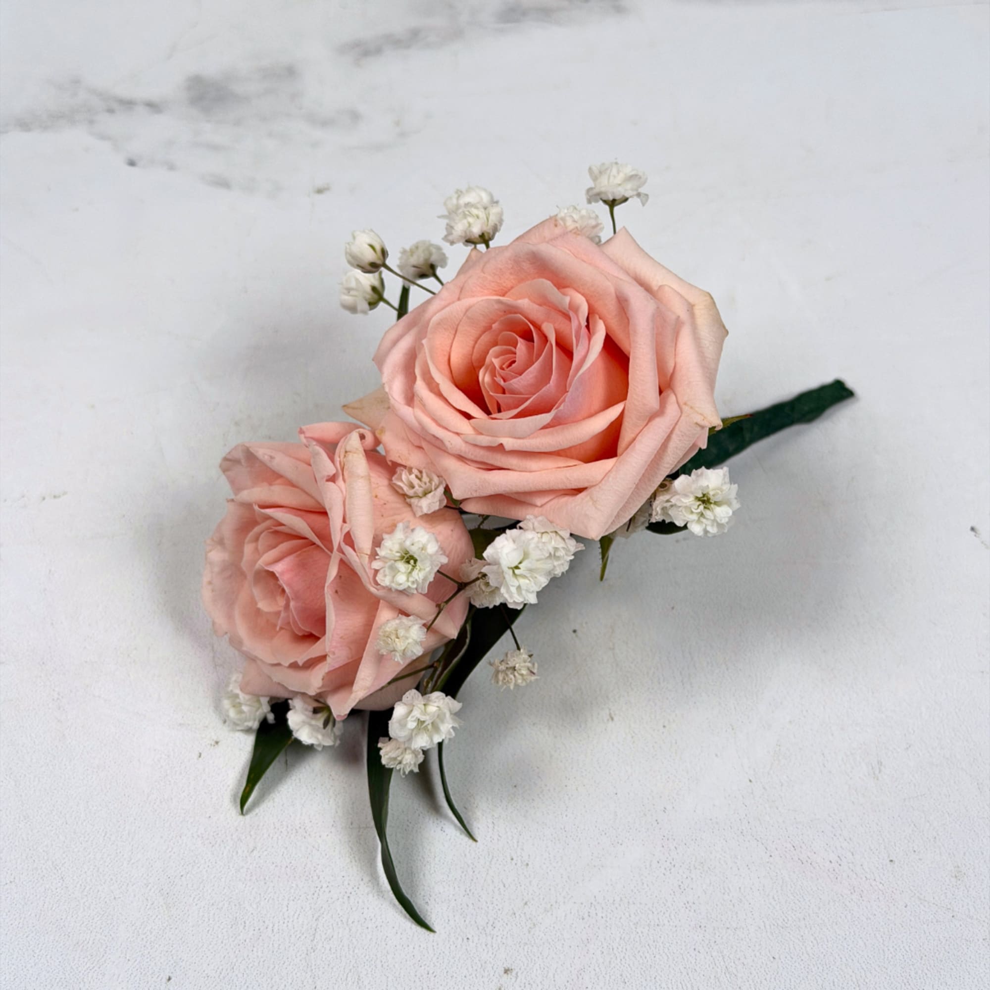 Two pale blush roses sit snugly together in this Rose Quartz boutonniere, photo 3 of 3