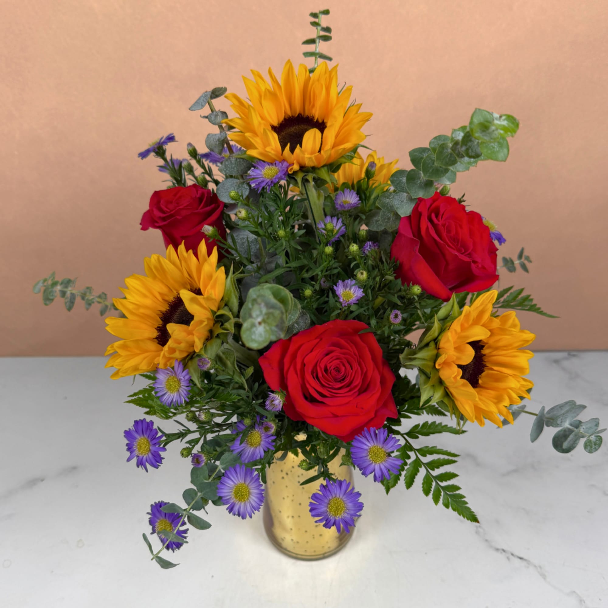 Bouquet of red roses, sunflowers, and purple daisies in a gold vase, photo 3 of 4
