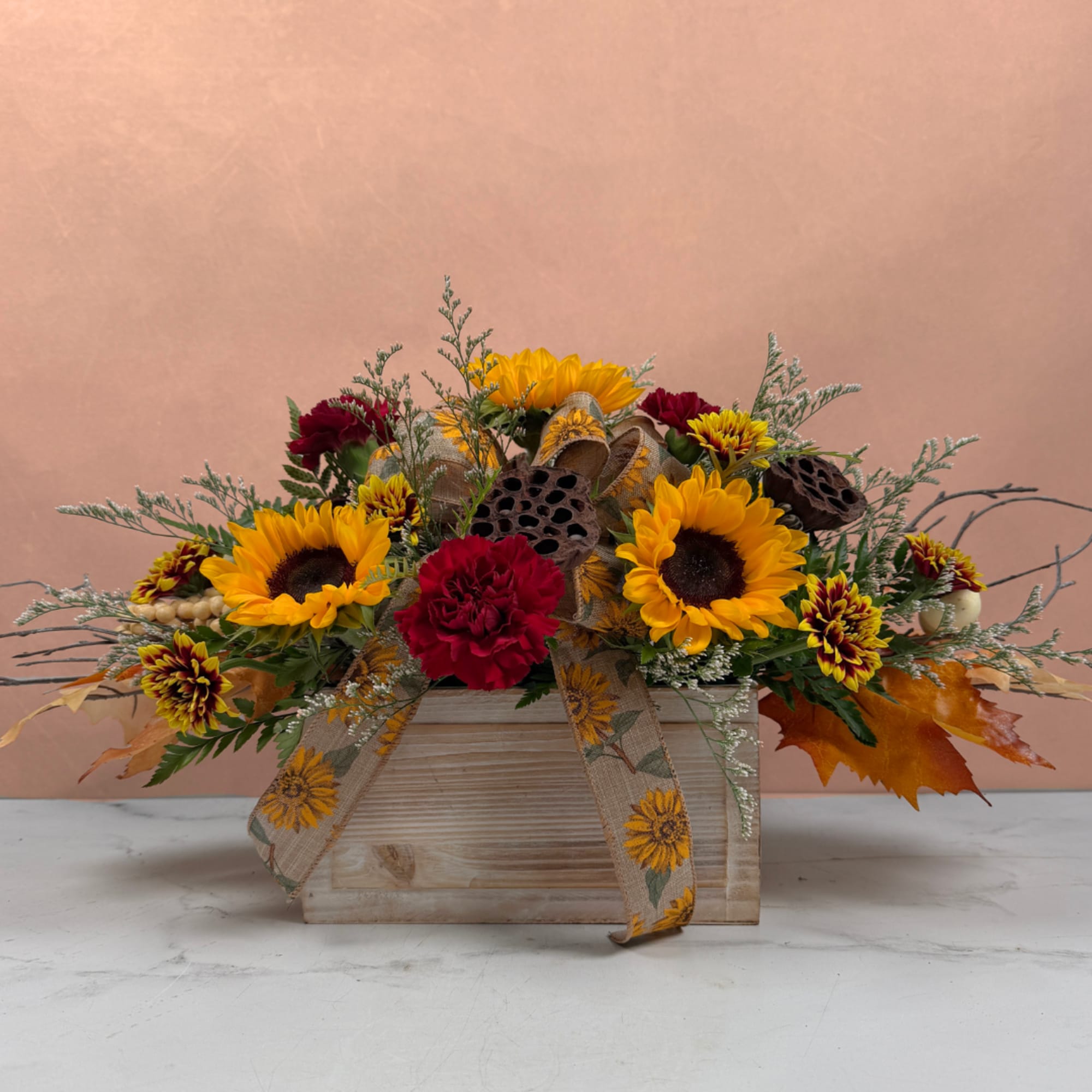Sunflower and carnation arrangement in a wooden box with ribbon