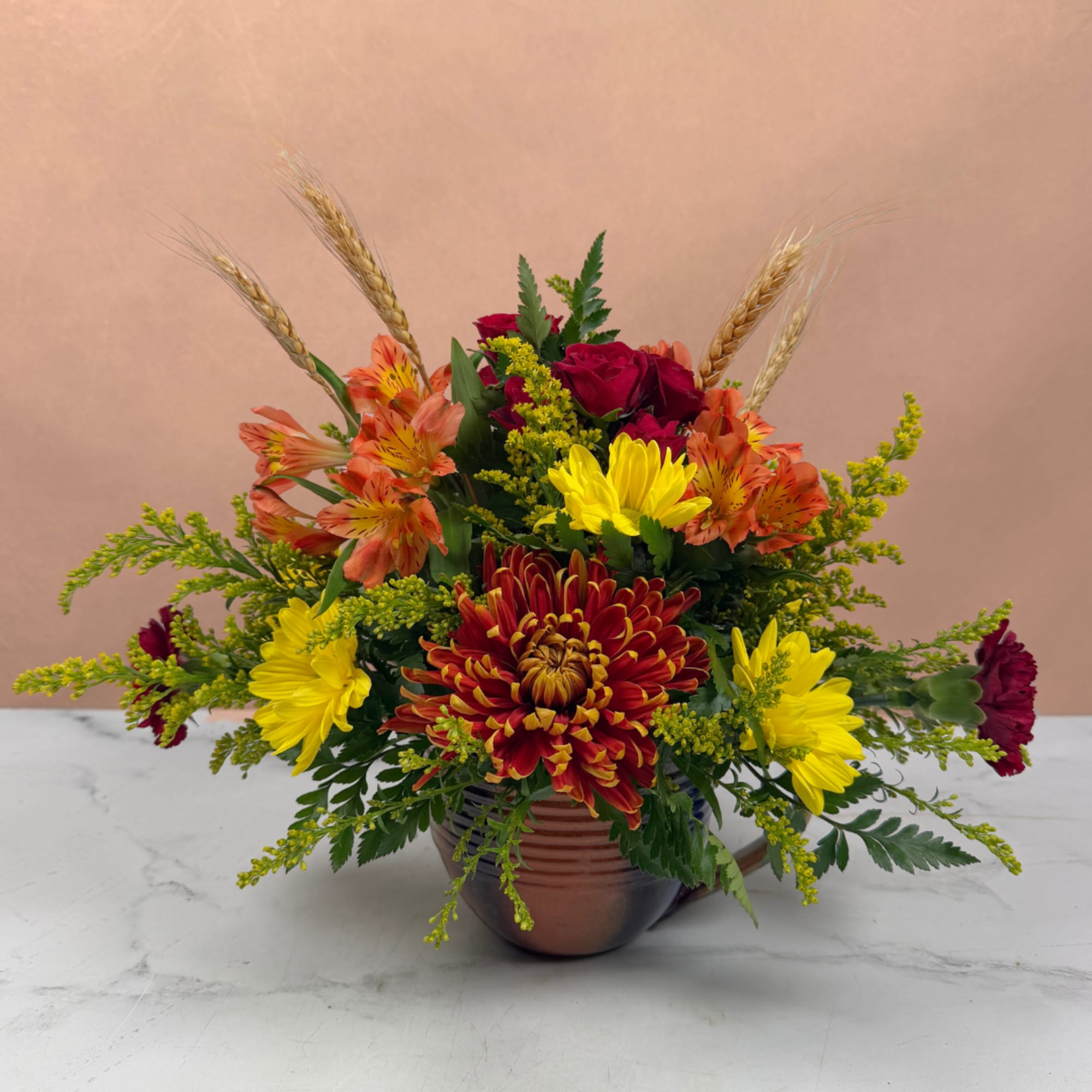 Mixed bouquet in a brown vase with red, yellow, and orange flowers