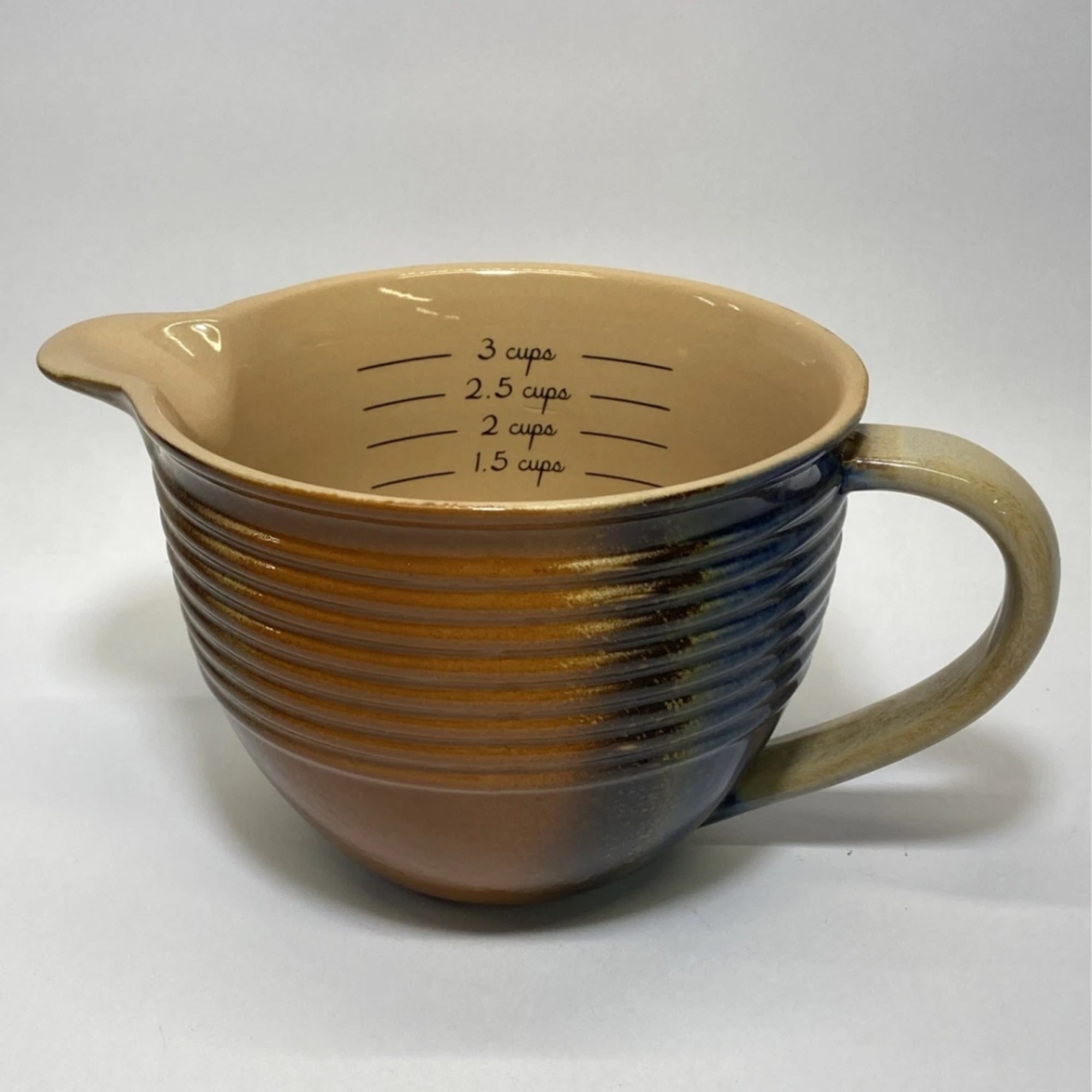 Ceramic measuring cup with a handle and pour spout