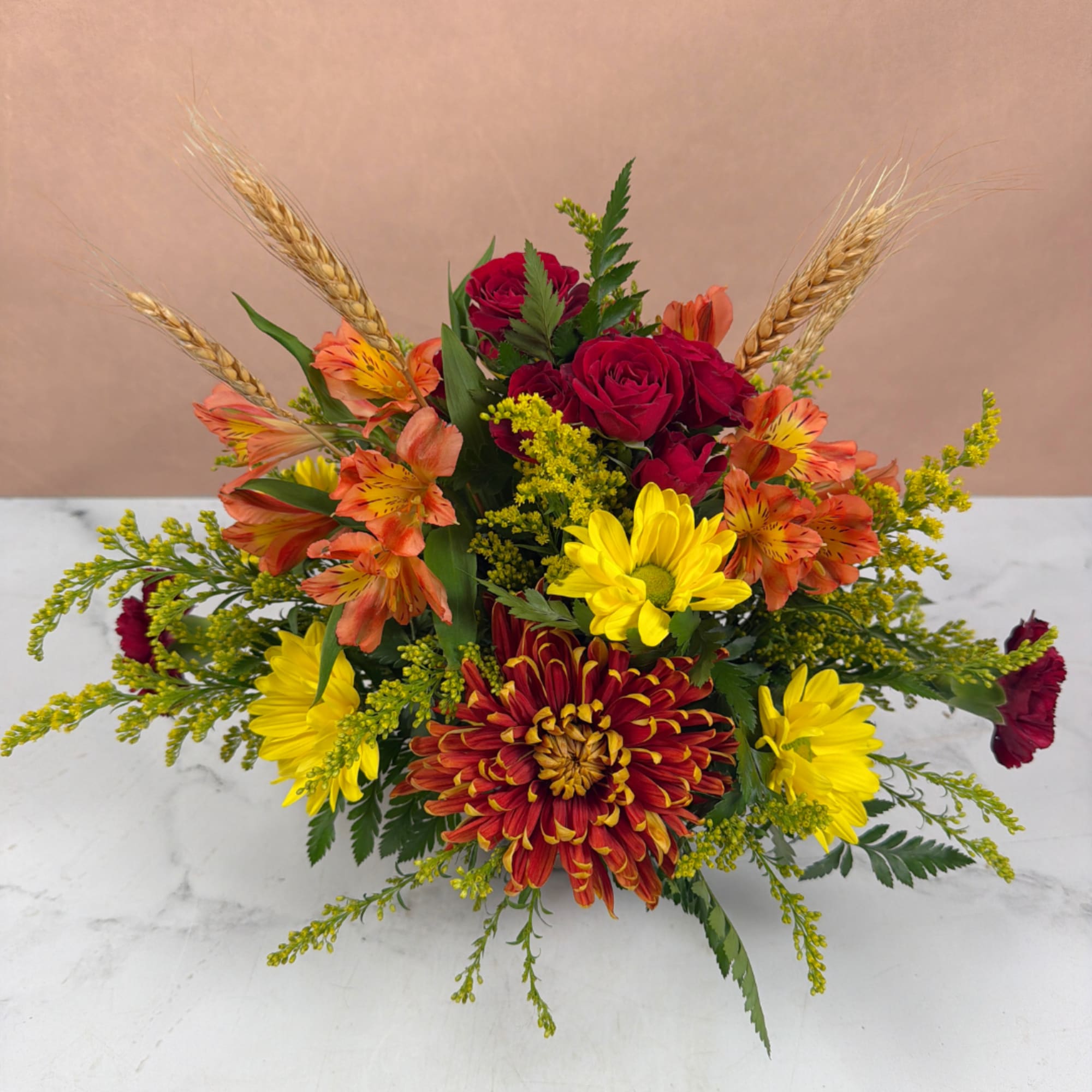 Mixed bouquet with red roses, yellow daisies, and orange alstroemeria