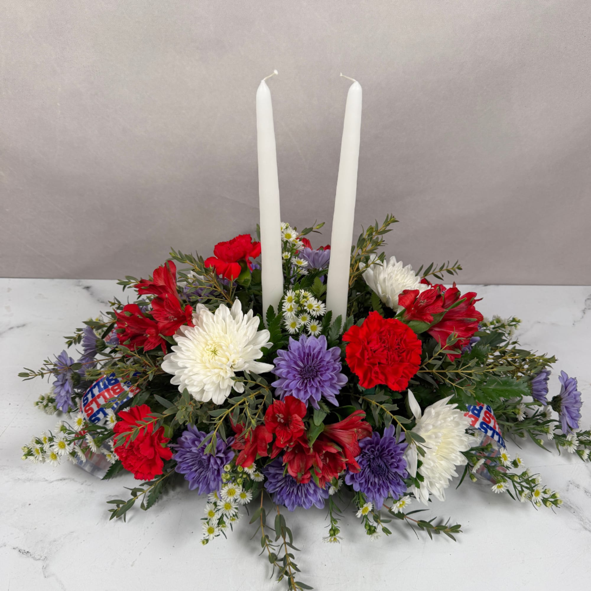 Red, white, and purple floral centerpiece with two white taper candles, photo 4 of 4