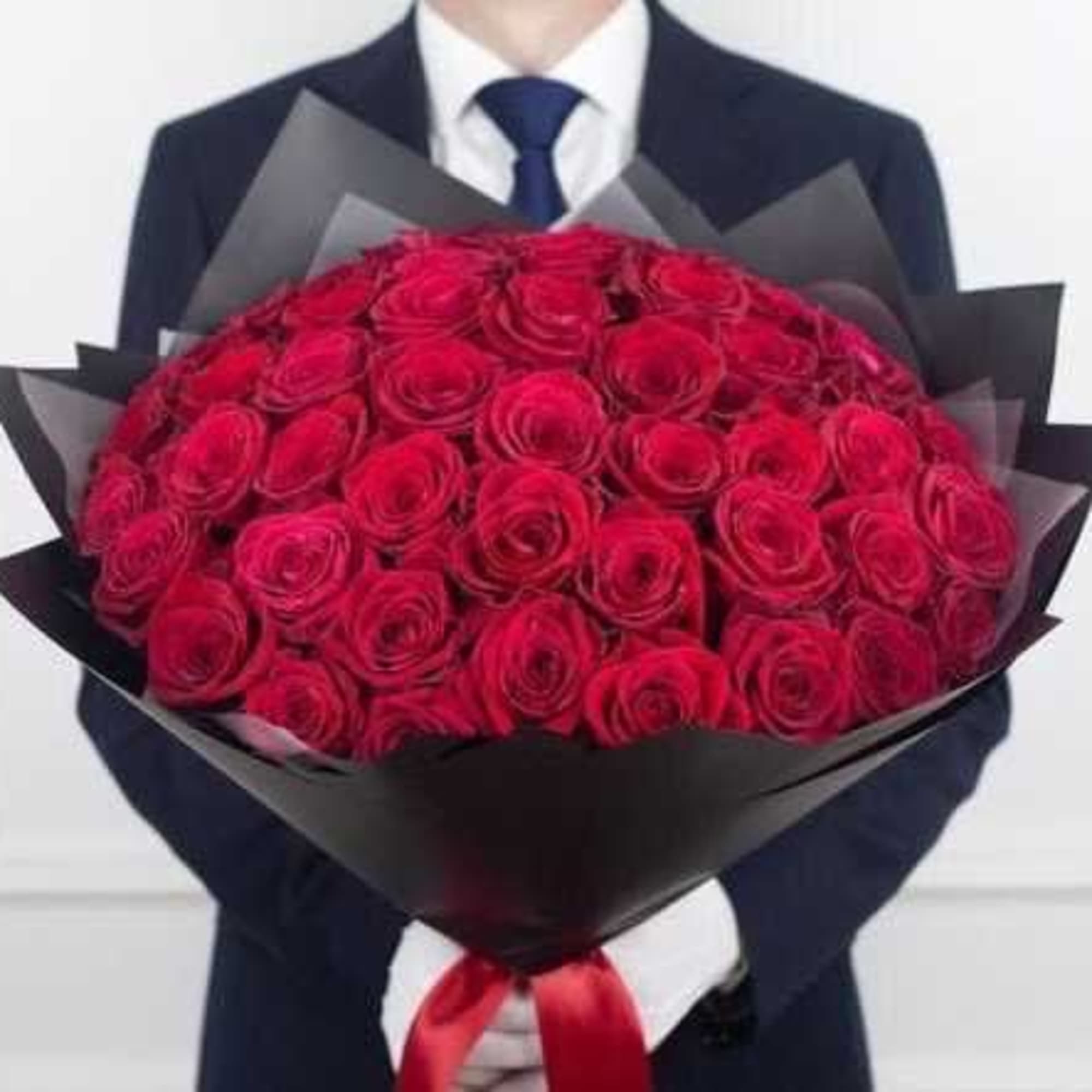Large bouquet of red roses wrapped in black paper