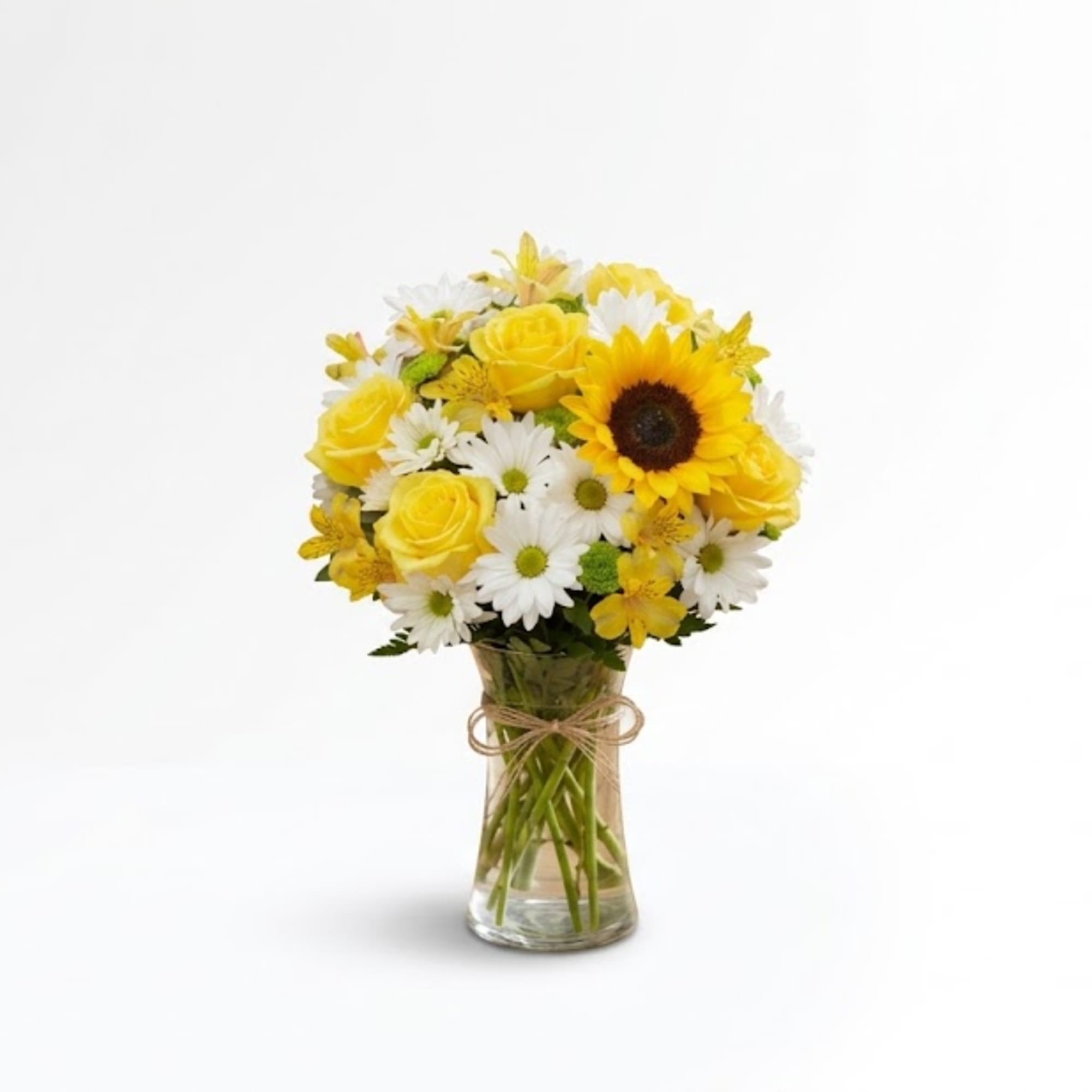 Yellow roses and daisies in a clear glass vase
