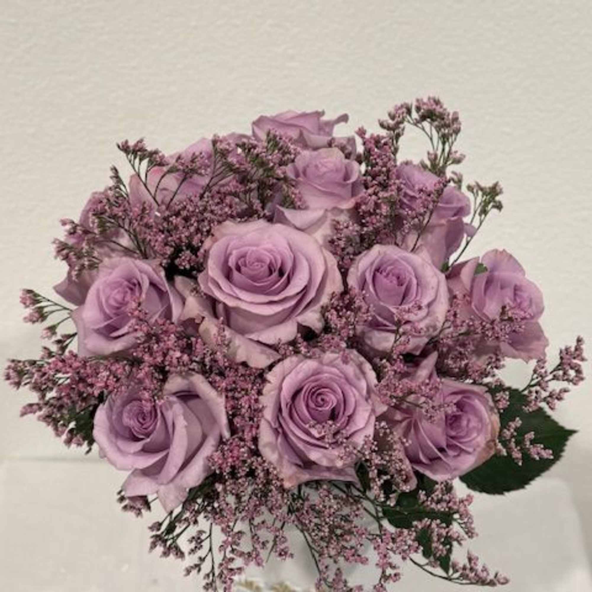 One Dozen lavender roses in glass vase 
