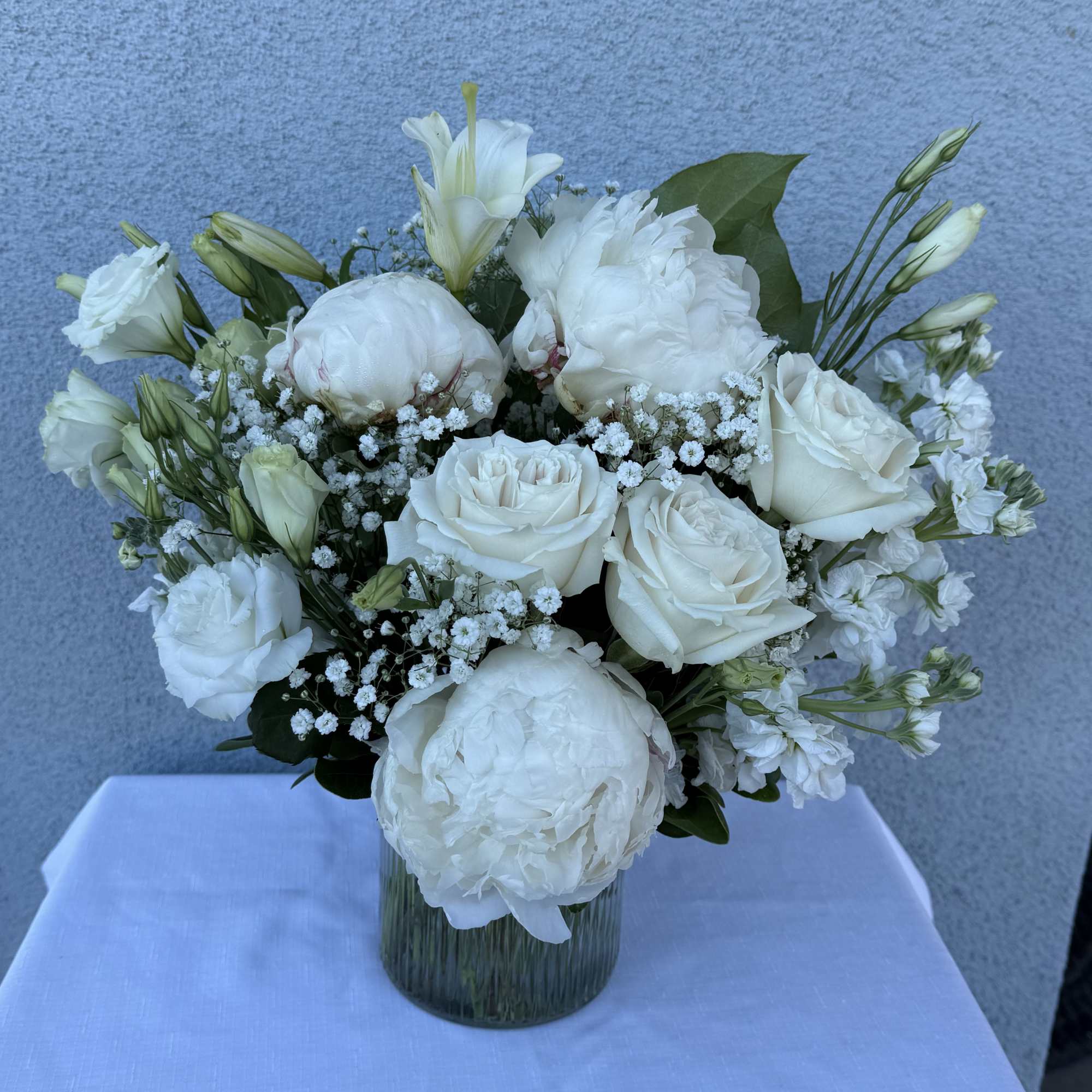 White arrangement filled with roses, stock flower, peony and lisianthus.  , photo 2 of 4