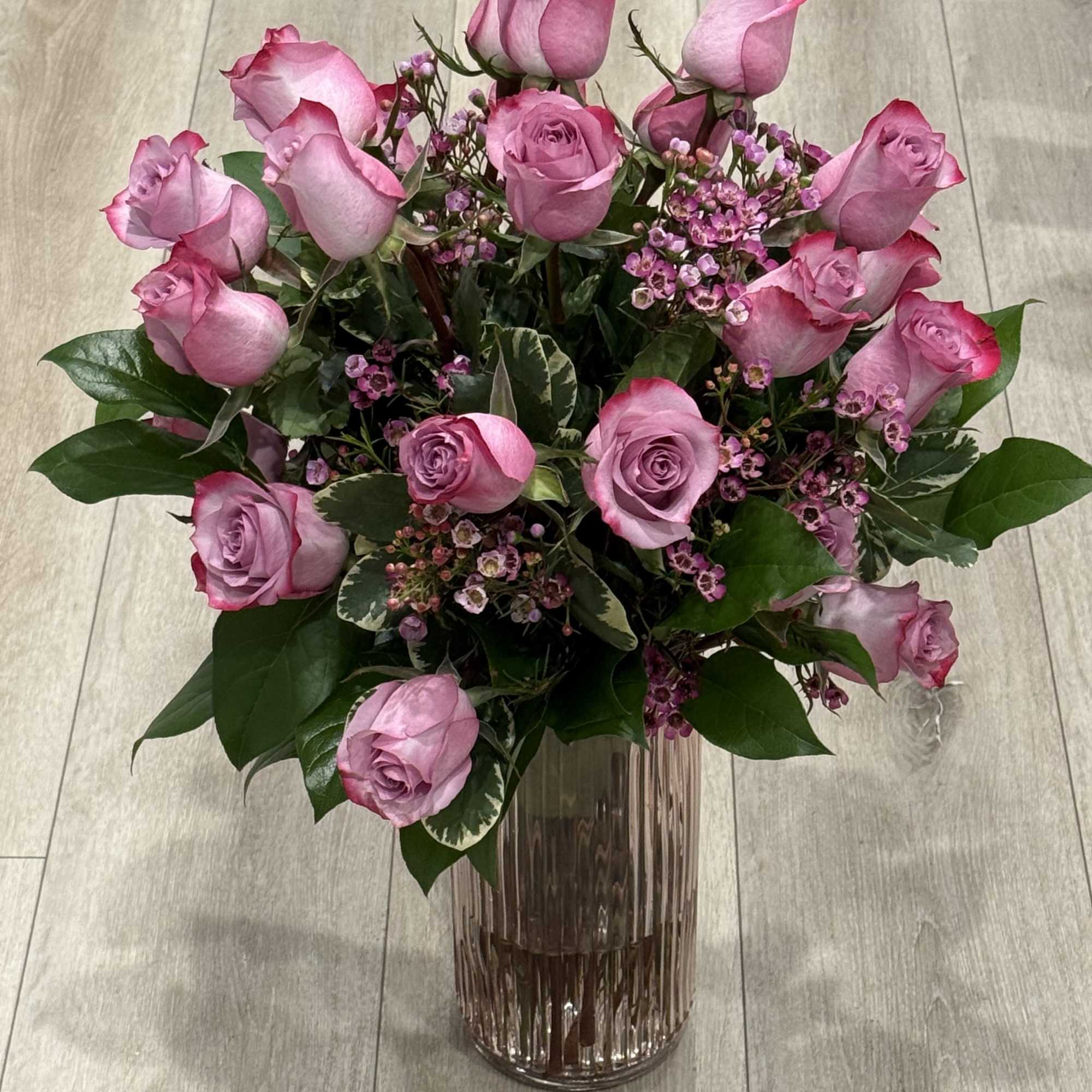Beautiful lavender bouquet
 
Dark lavender bicolor roses, wax flower and in season