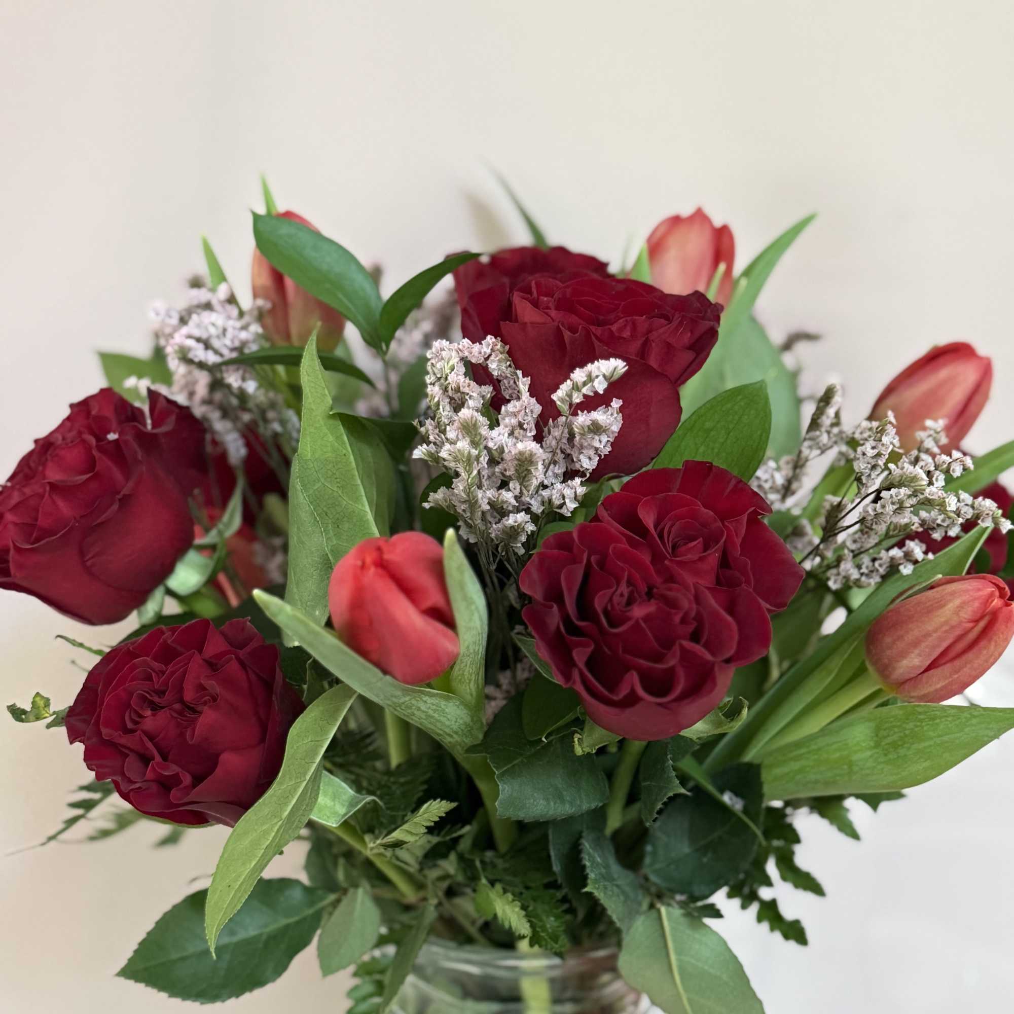 Garden Roses, tulips, seasonal greens and limonium., photo 2 of 3