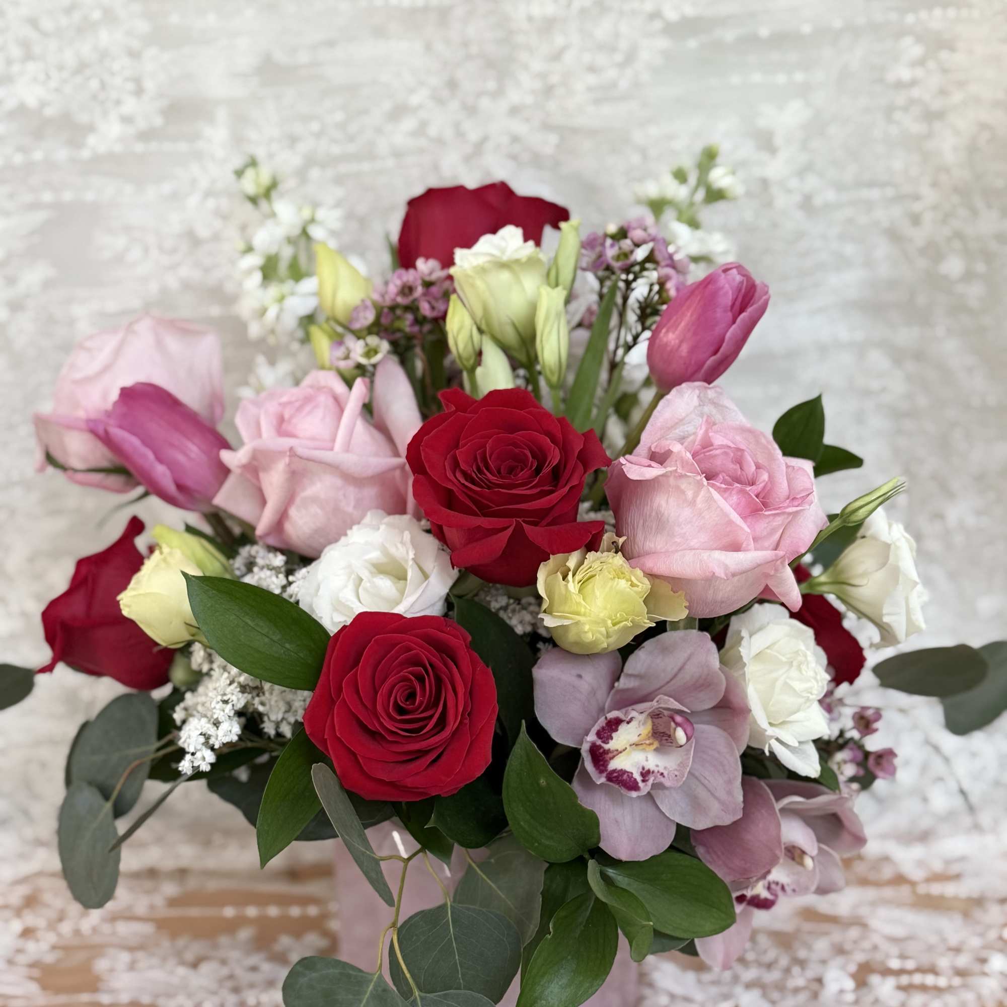 Lux arrangement with Tulips, Orchids, Roses, Lisianthus, wax flower stock flower with
