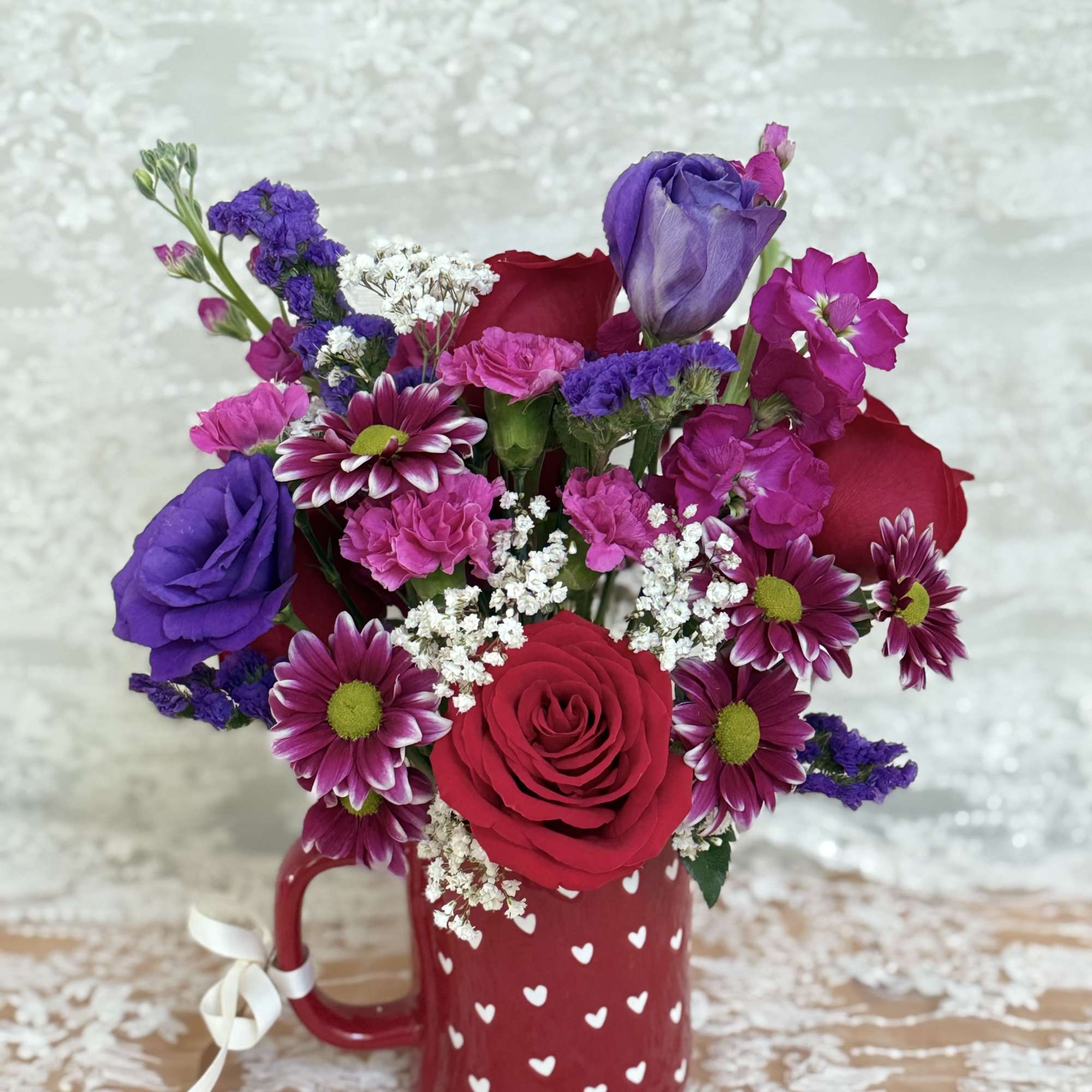 Coffee mug filled with roses, lisianthus, and spray mums., photo 2 of 3