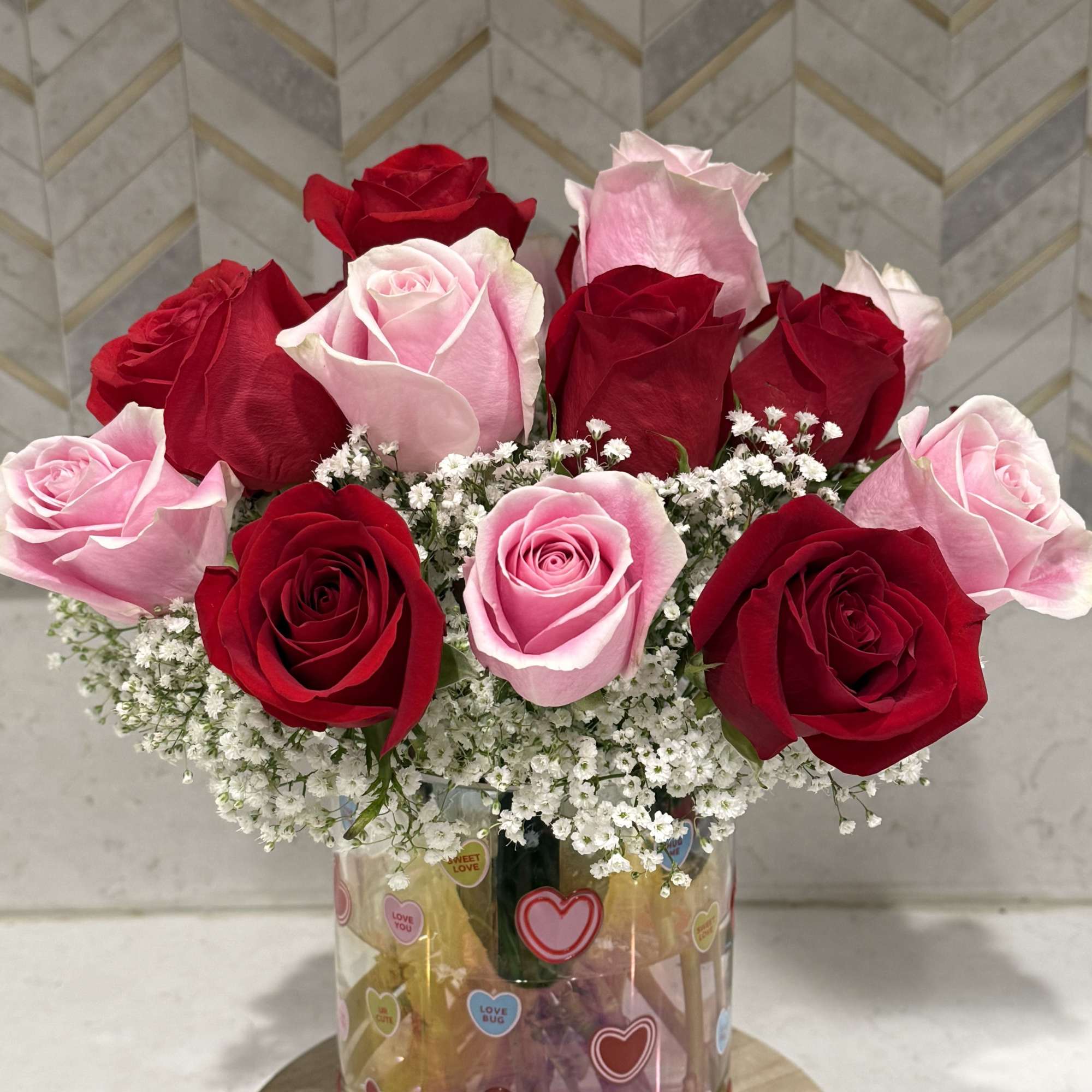 Mix of red and pink roses in a sweetheart vase

Two dozen roses