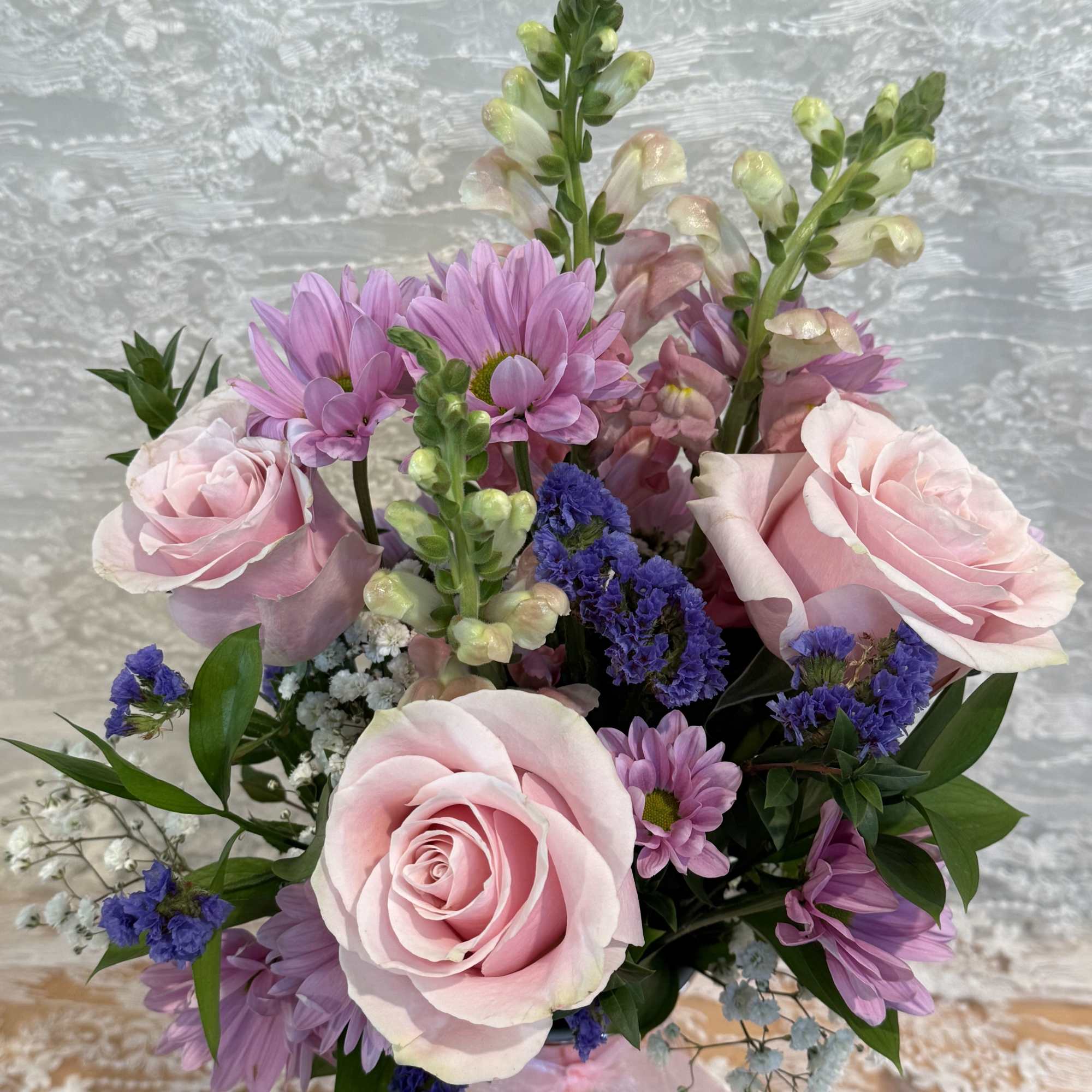 Arrangement filled with light pink roses, spray daisies and snapdragons. , photo 2 of 2