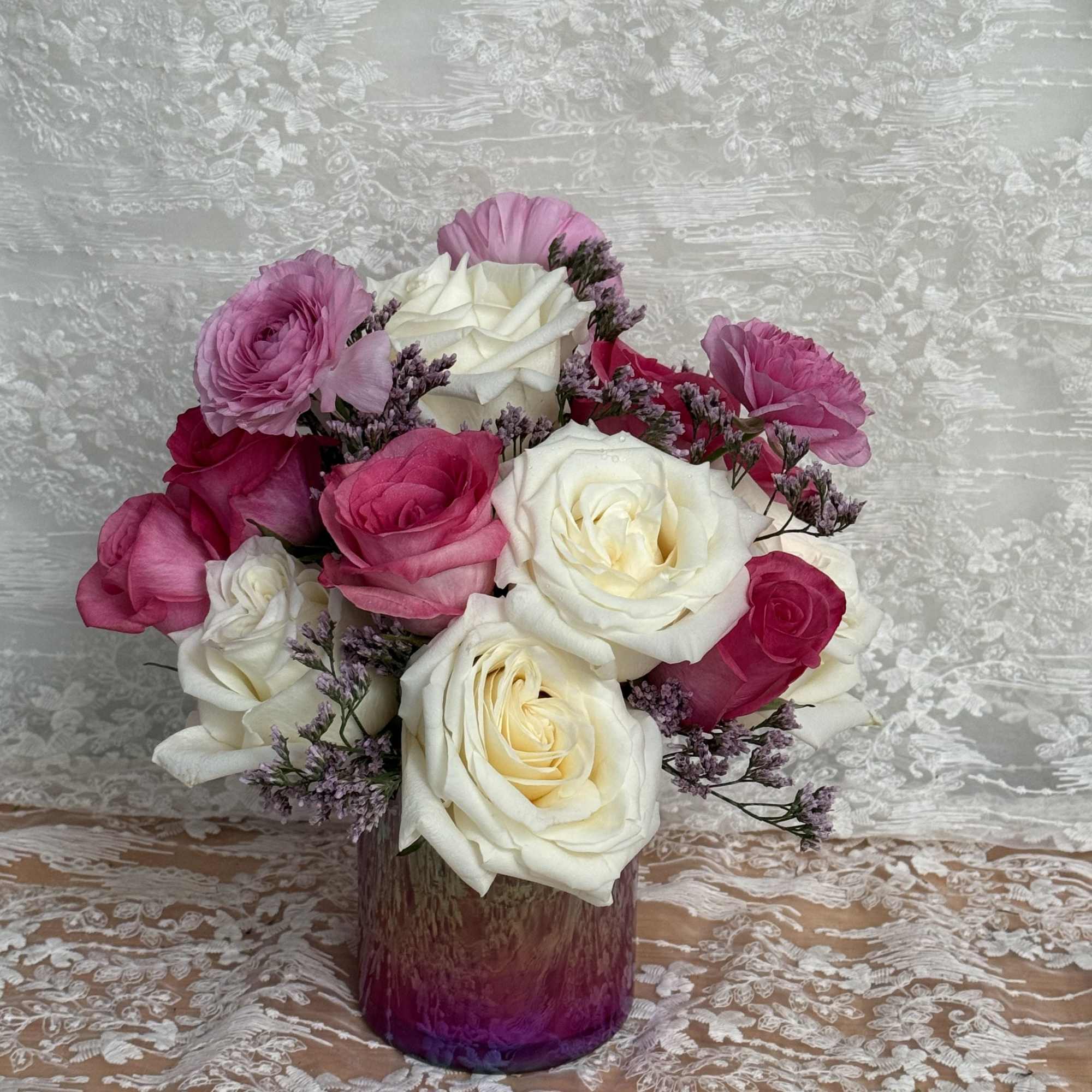 Small arrangement with cream roses, pink roses and ranunculus 