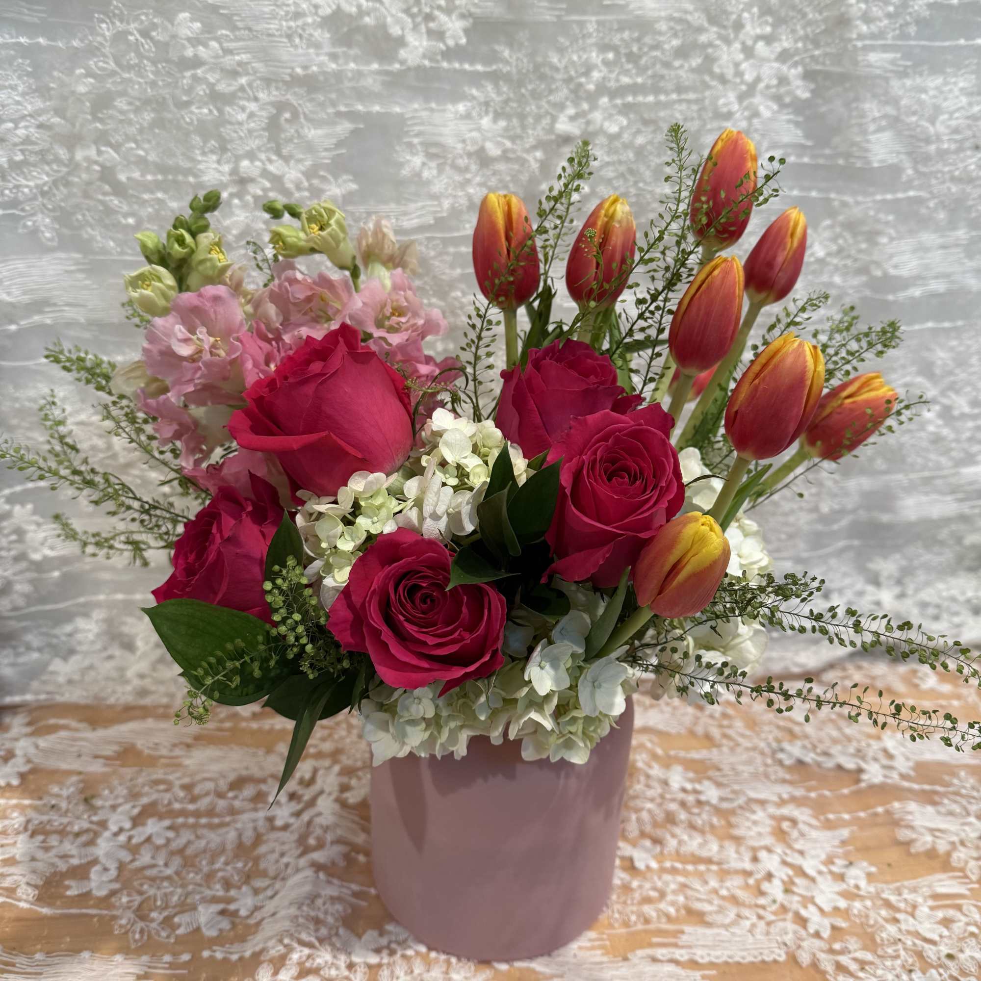 Hot pink roses, pink snap dragons, white hydrangeas and orange tulips 