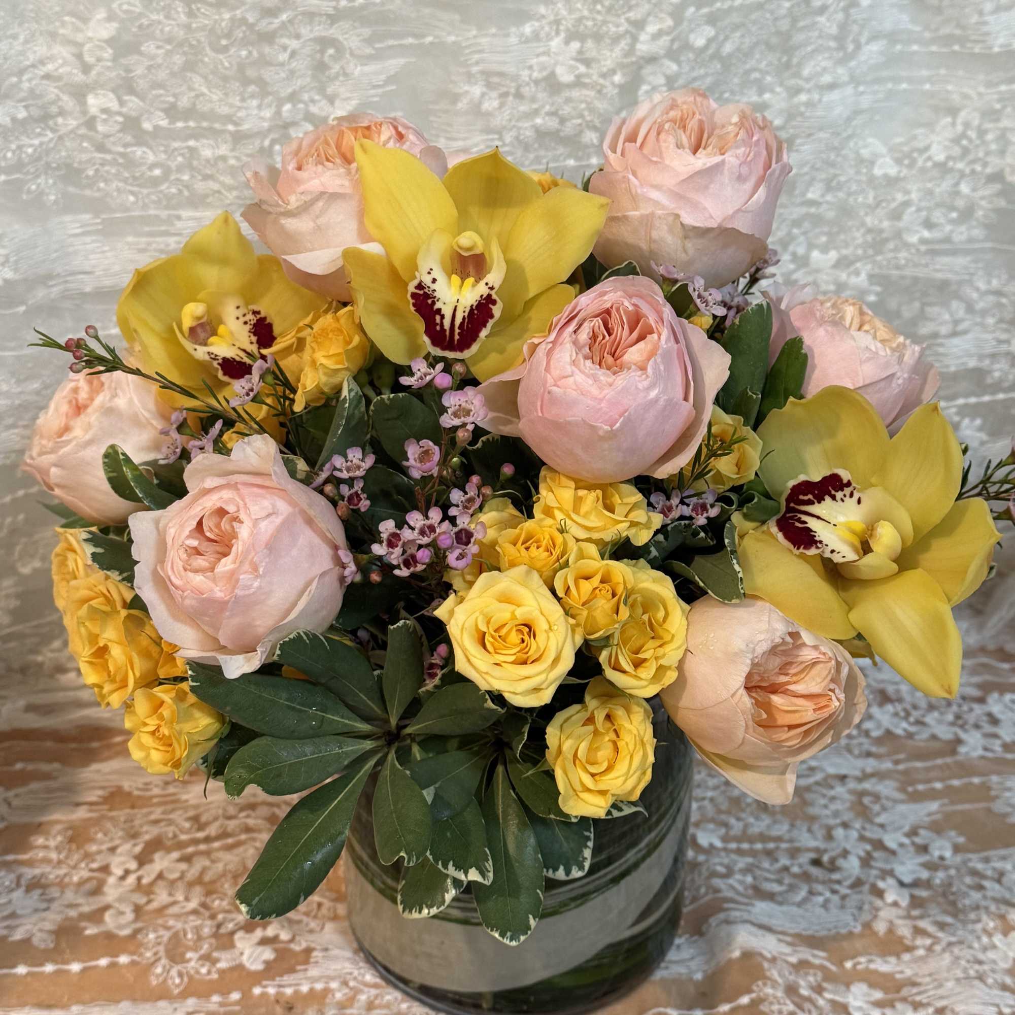 Garden roses, spray roses, orchids, wax flower and  seasonal greenery., photo 2 of 2