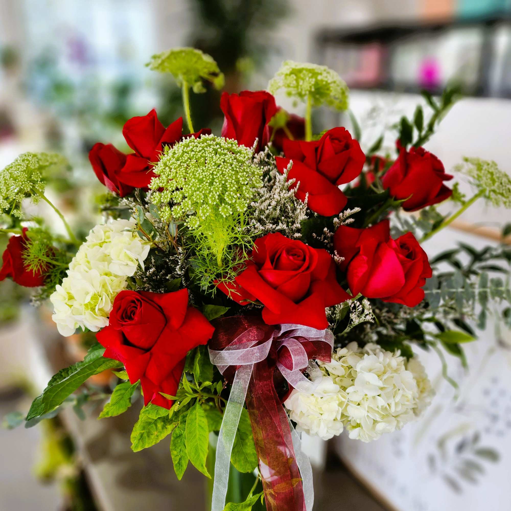 Bouquet of red roses and white hydrangeas with a ribbon tie