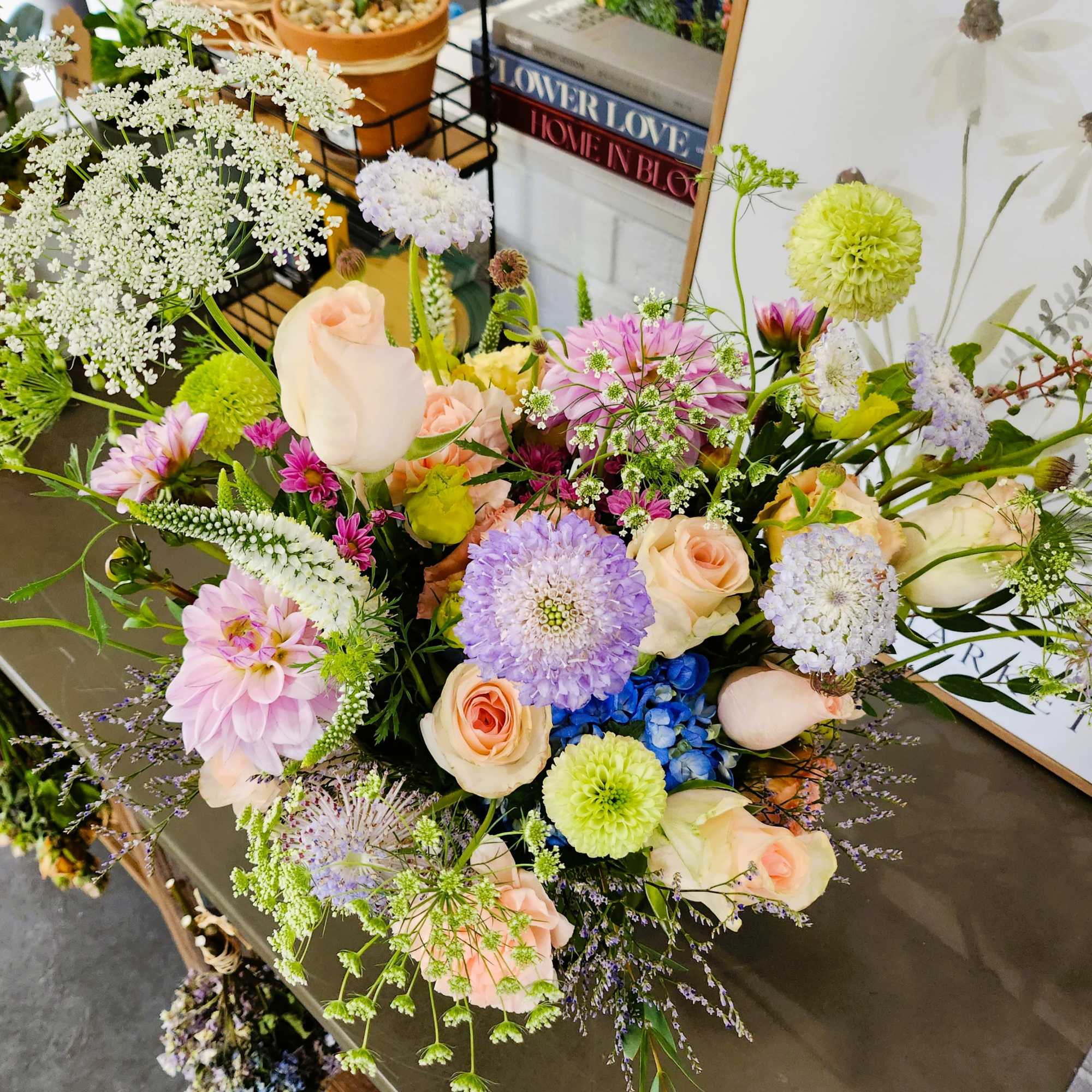 Mixed bouquet of pastel roses, dahlias, and filler flowers