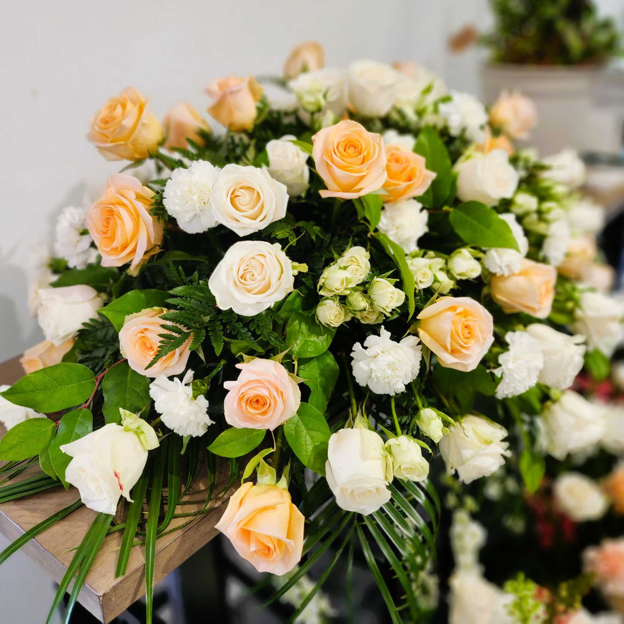 Bouquet of peach and white roses with white filler flowers