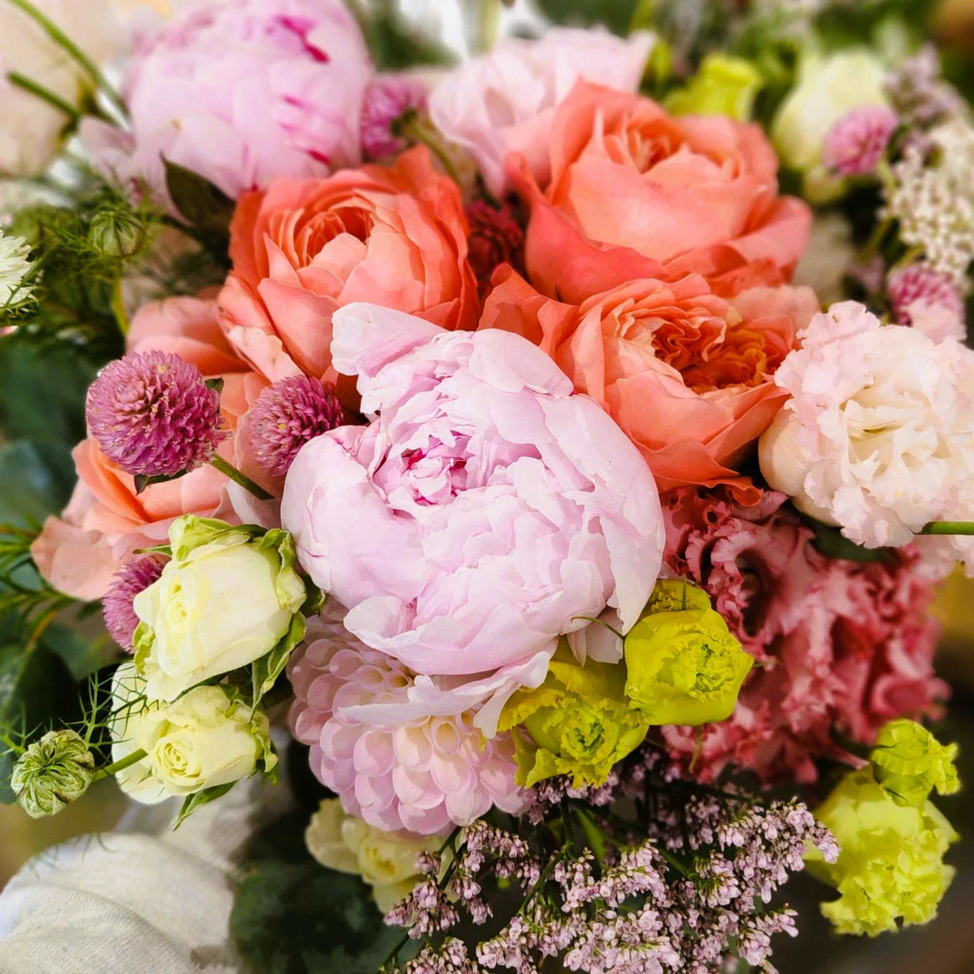 Bouquet of pink and peach flowers with pale yellow accents