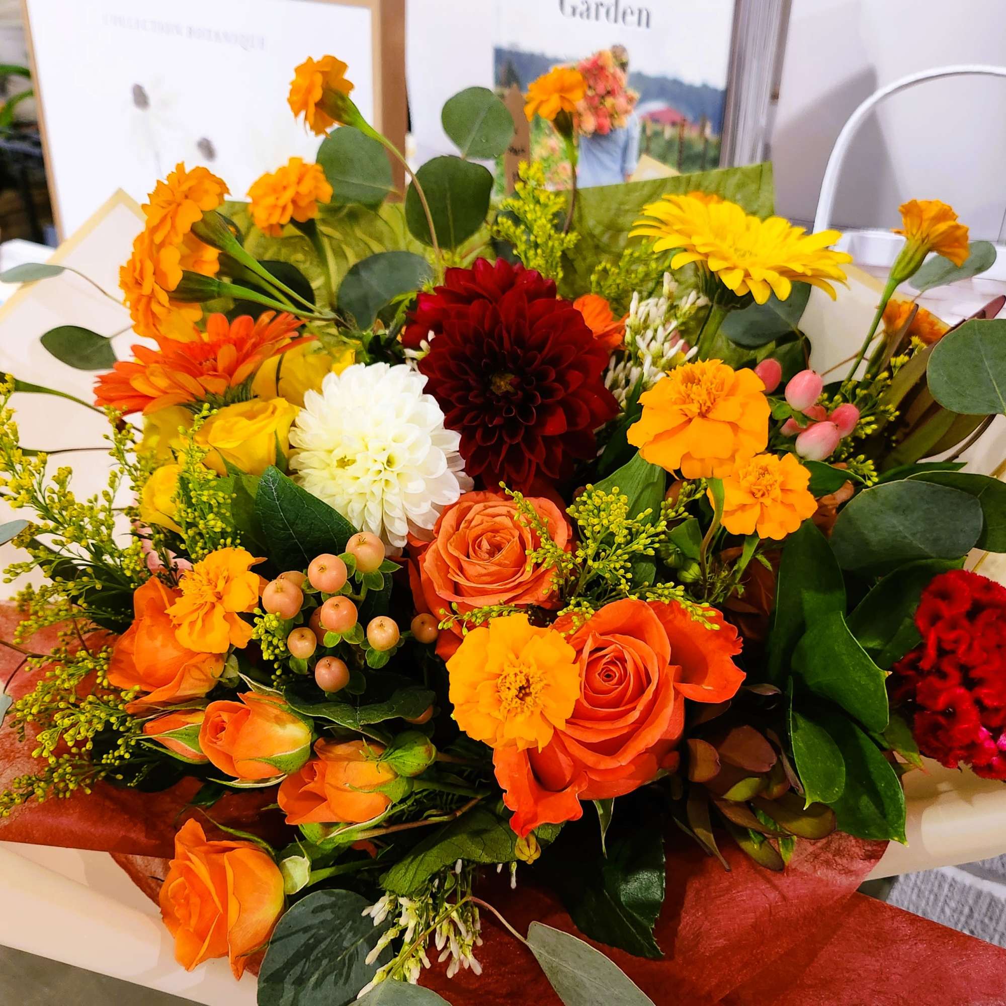 Mixed bouquet of orange, yellow, white, and red flowers