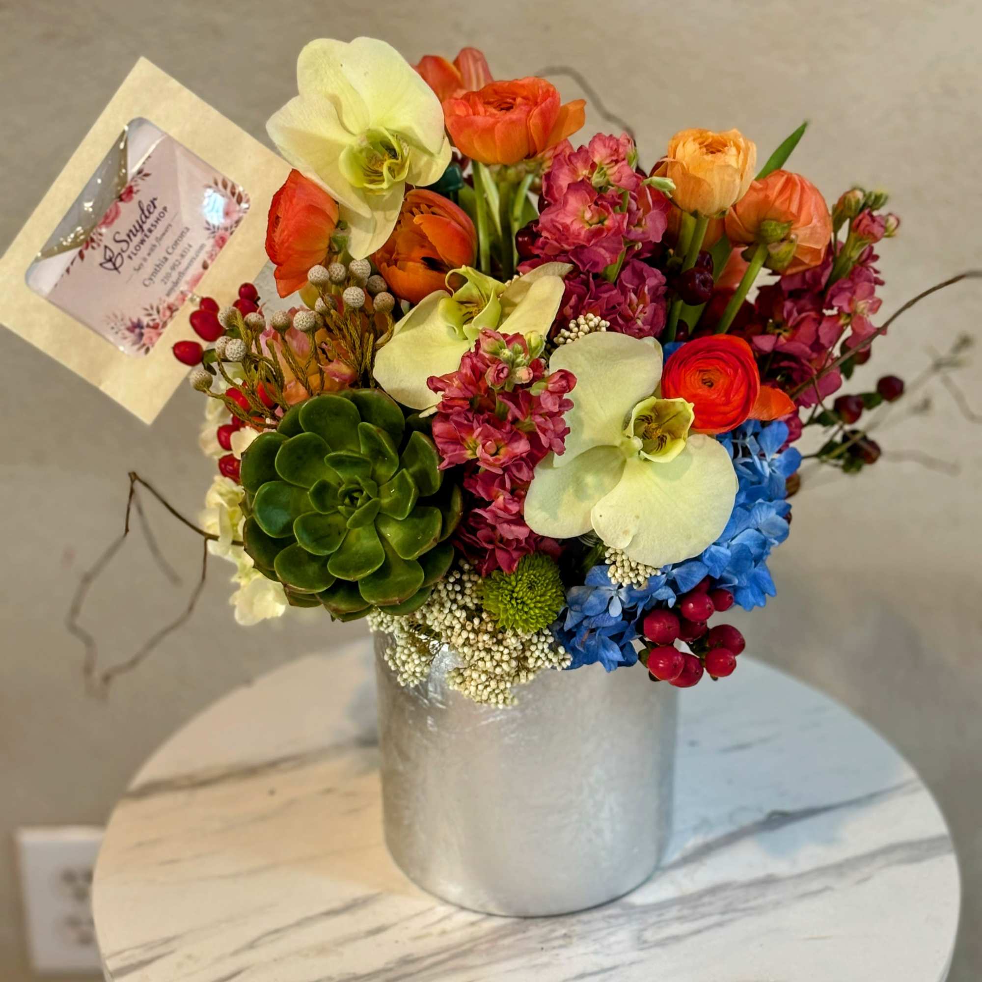 Orchid Sunset Luxe is a sophisticated modern floral arrangement featuring elegant Phalaenopsis