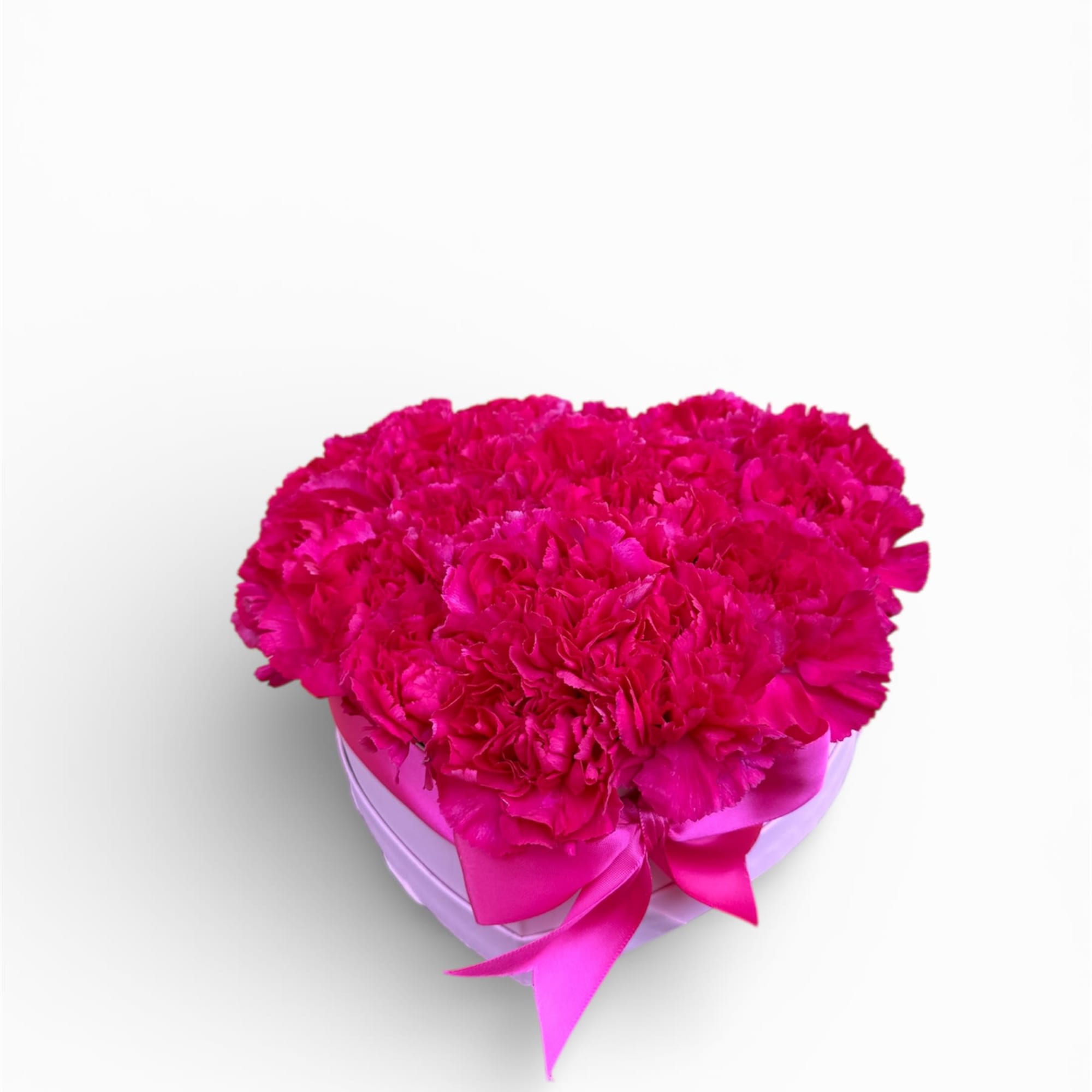 Hot pink carnation arrangement in a heart-shaped box with ribbon