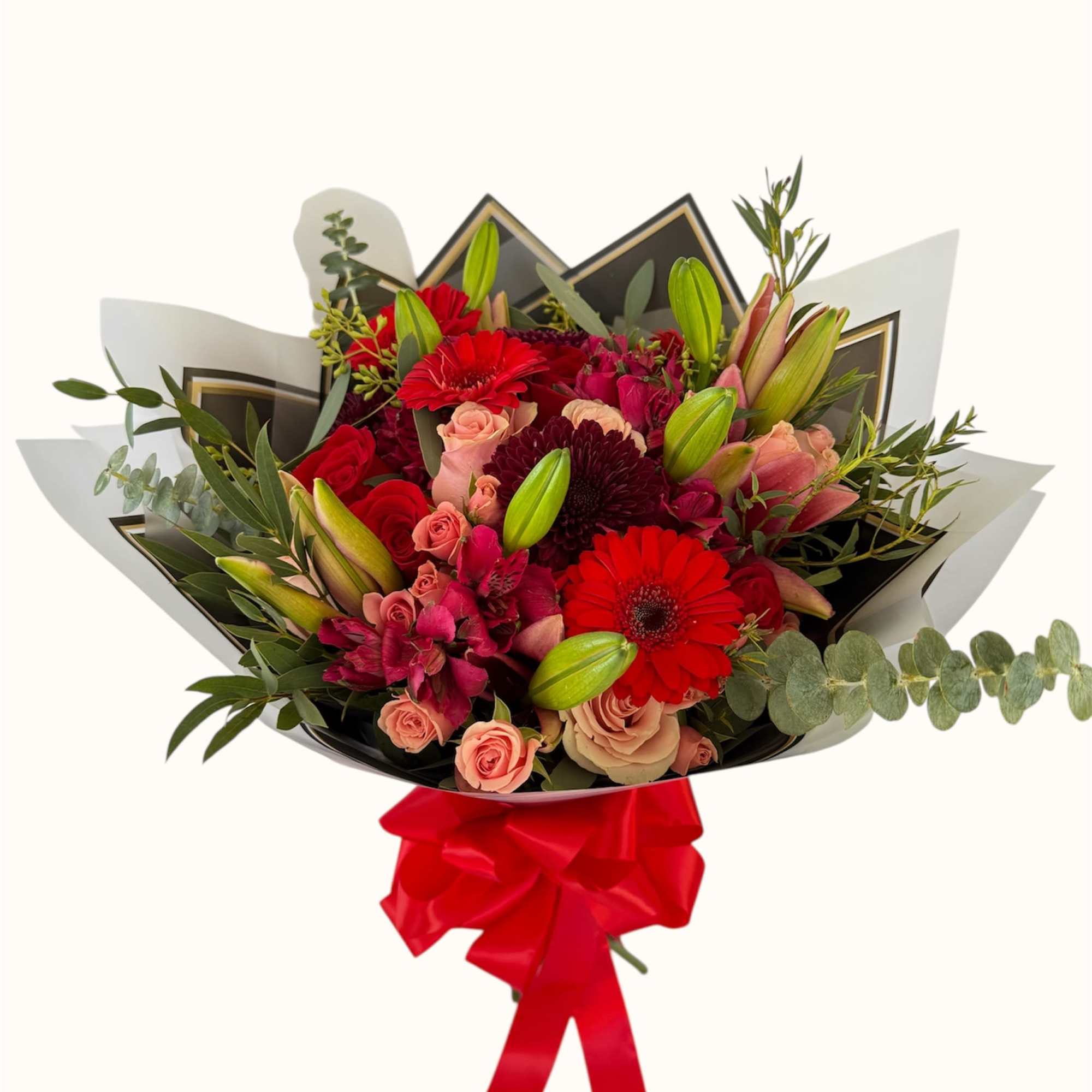 Bouquet of red and pink flowers wrapped with black paper and a red ribbon