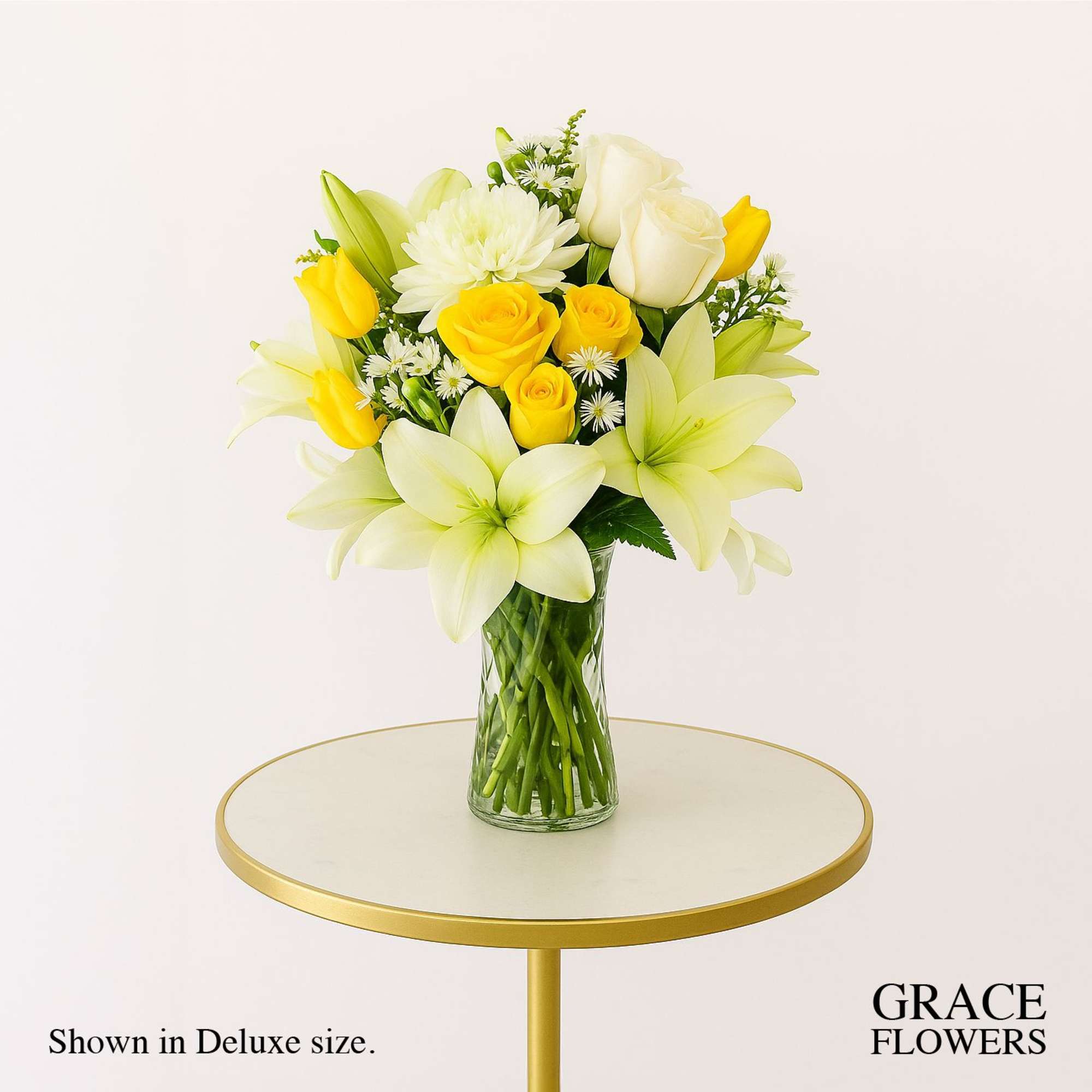 Yellow and white bouquet in a clear glass vase