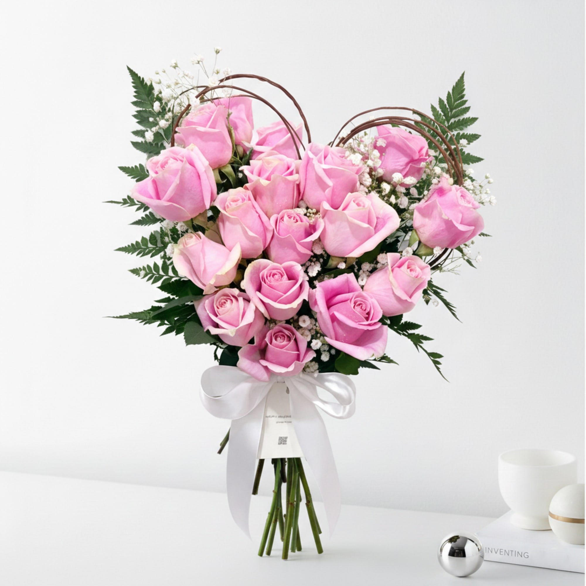 Bouquet of pink roses with baby's breath and a white ribbon