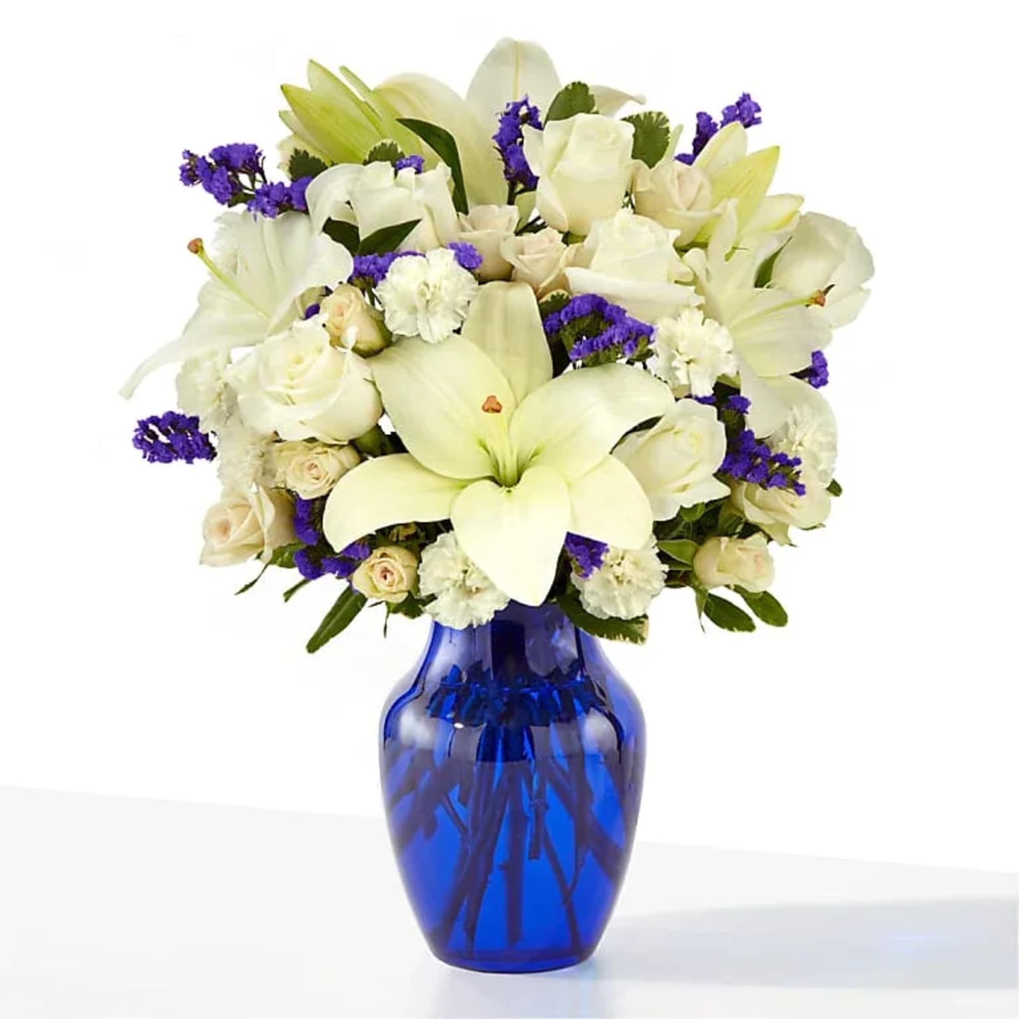 Pure white lilies and cream roses set against vivid purple accents make