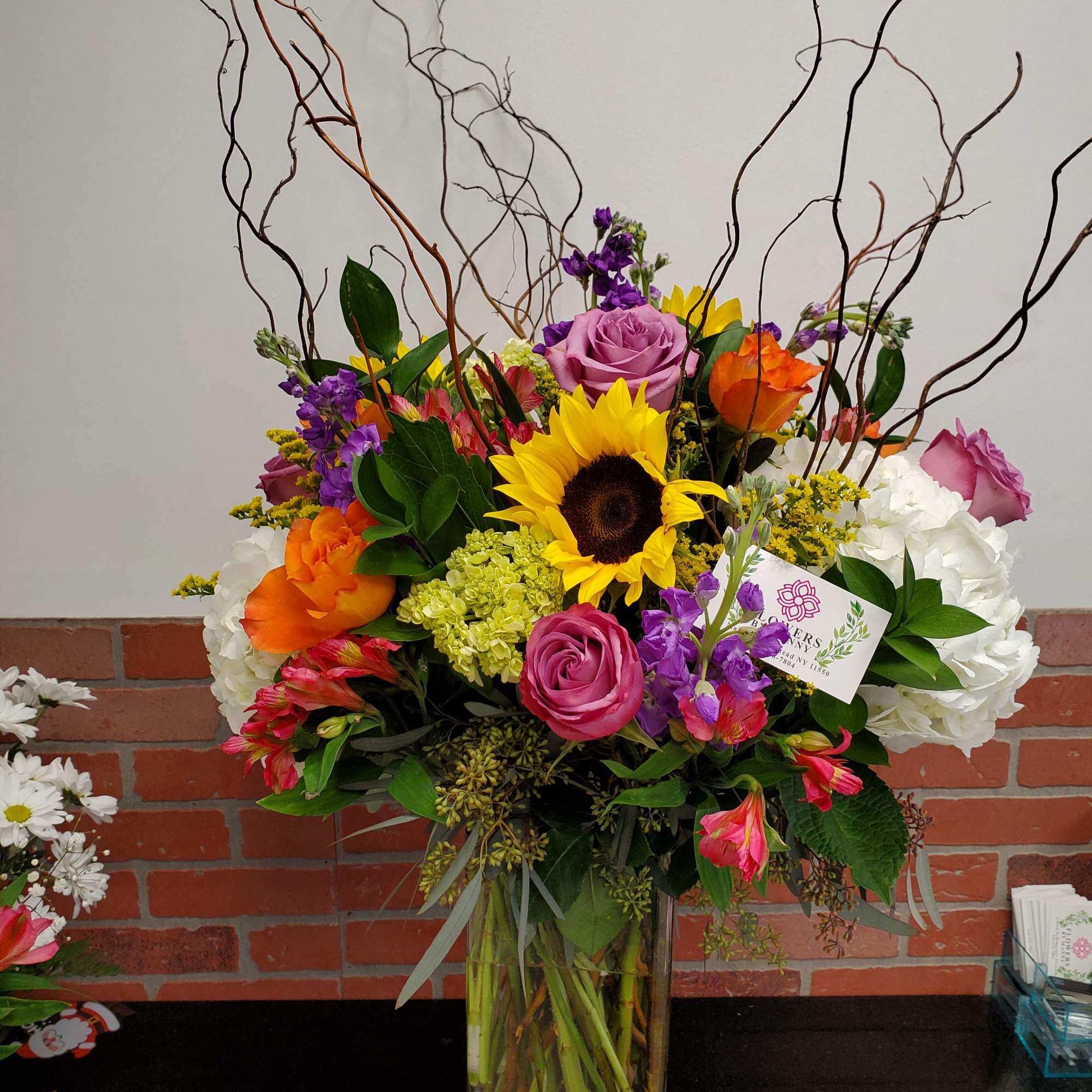 A beautiful mix of flowers in a clear vase, photo 2 of 2