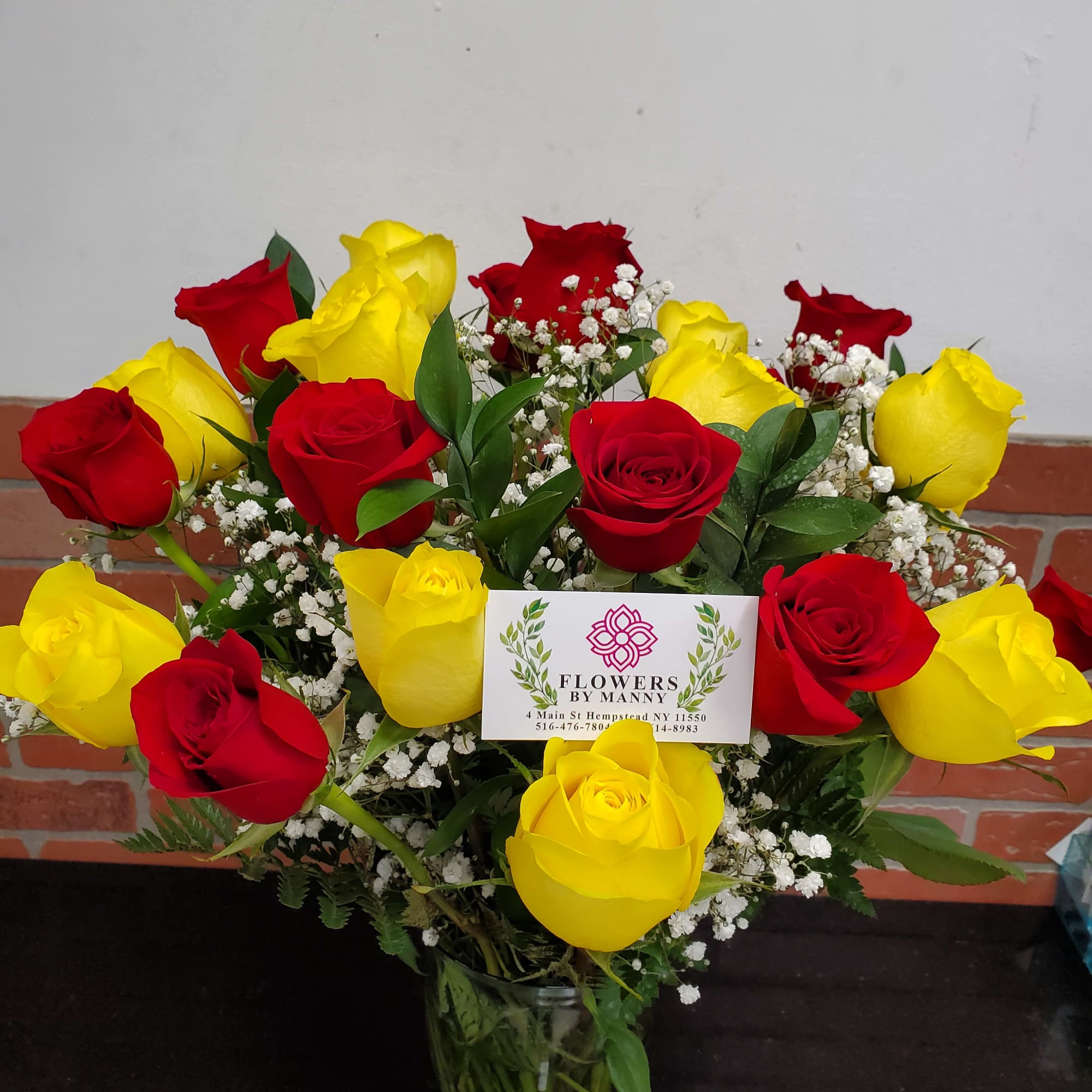 12 yellow roses and 12 red roses in vase with BB.
