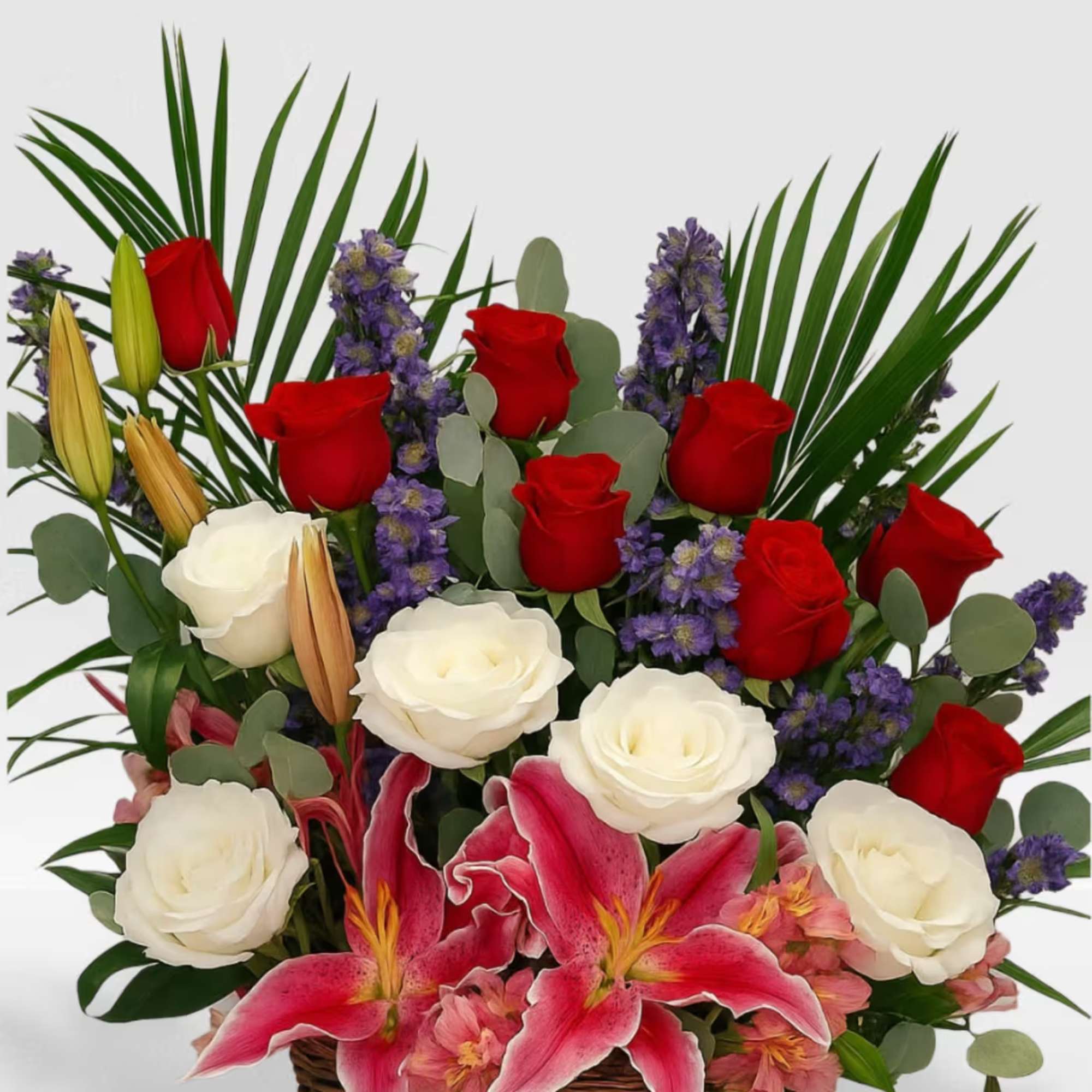 Red roses, white roses, stargazer lilys in a basket full of love.