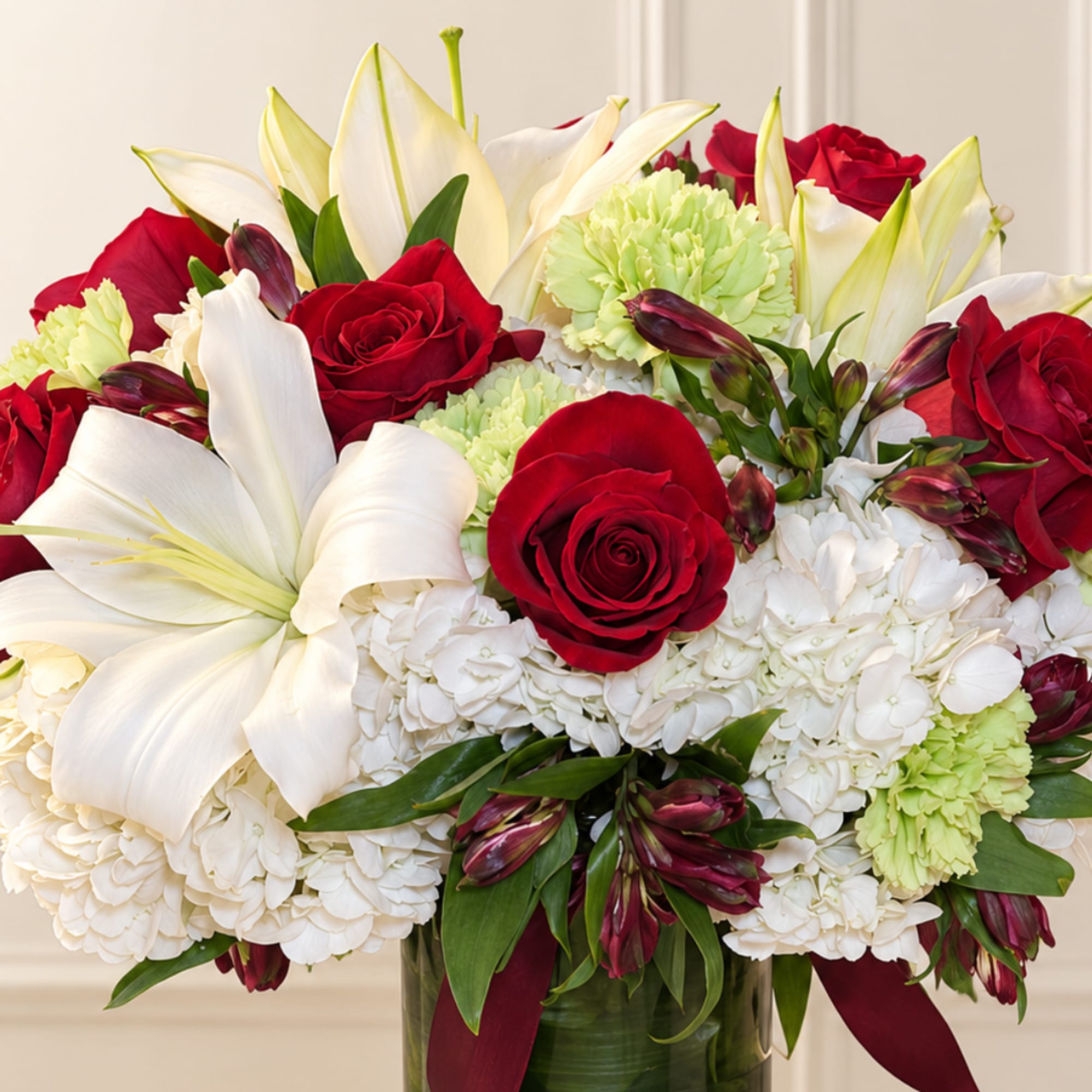 Red roses and white lilies in a glass vase with white hydrangeas, photo 2 of 3