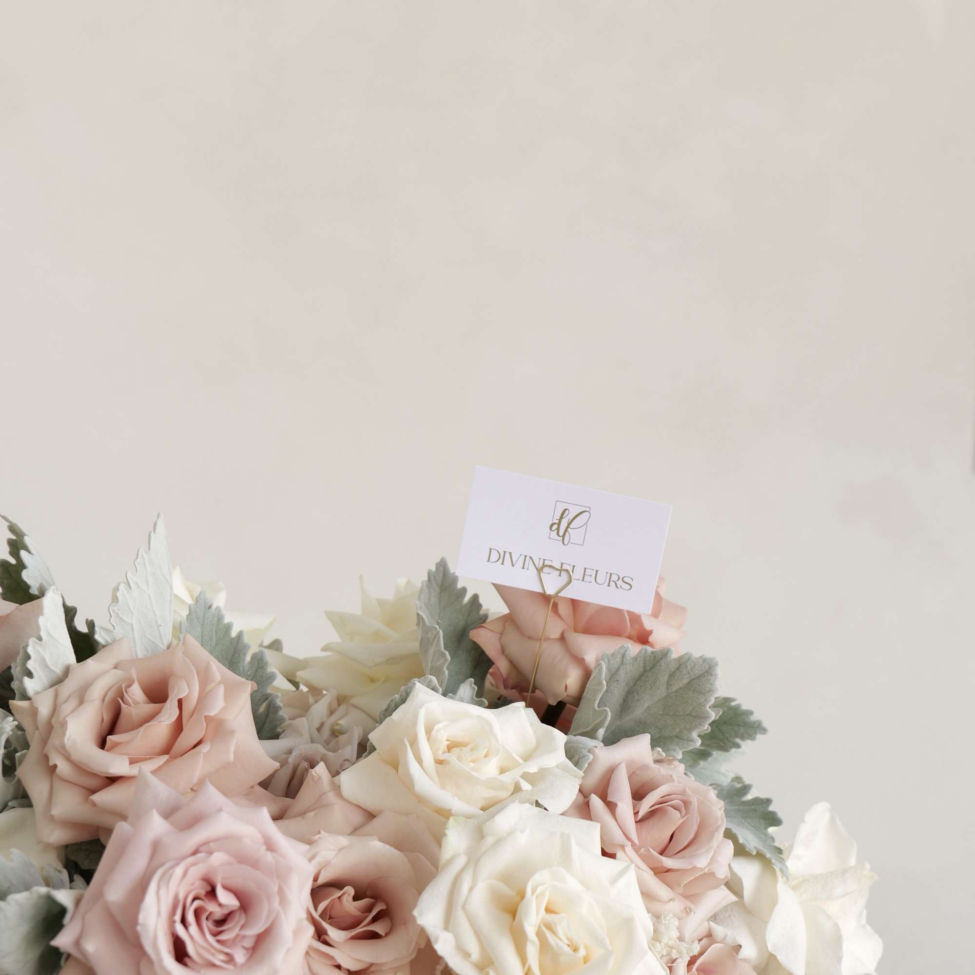Bouquet of blush and white roses with silvery foliage