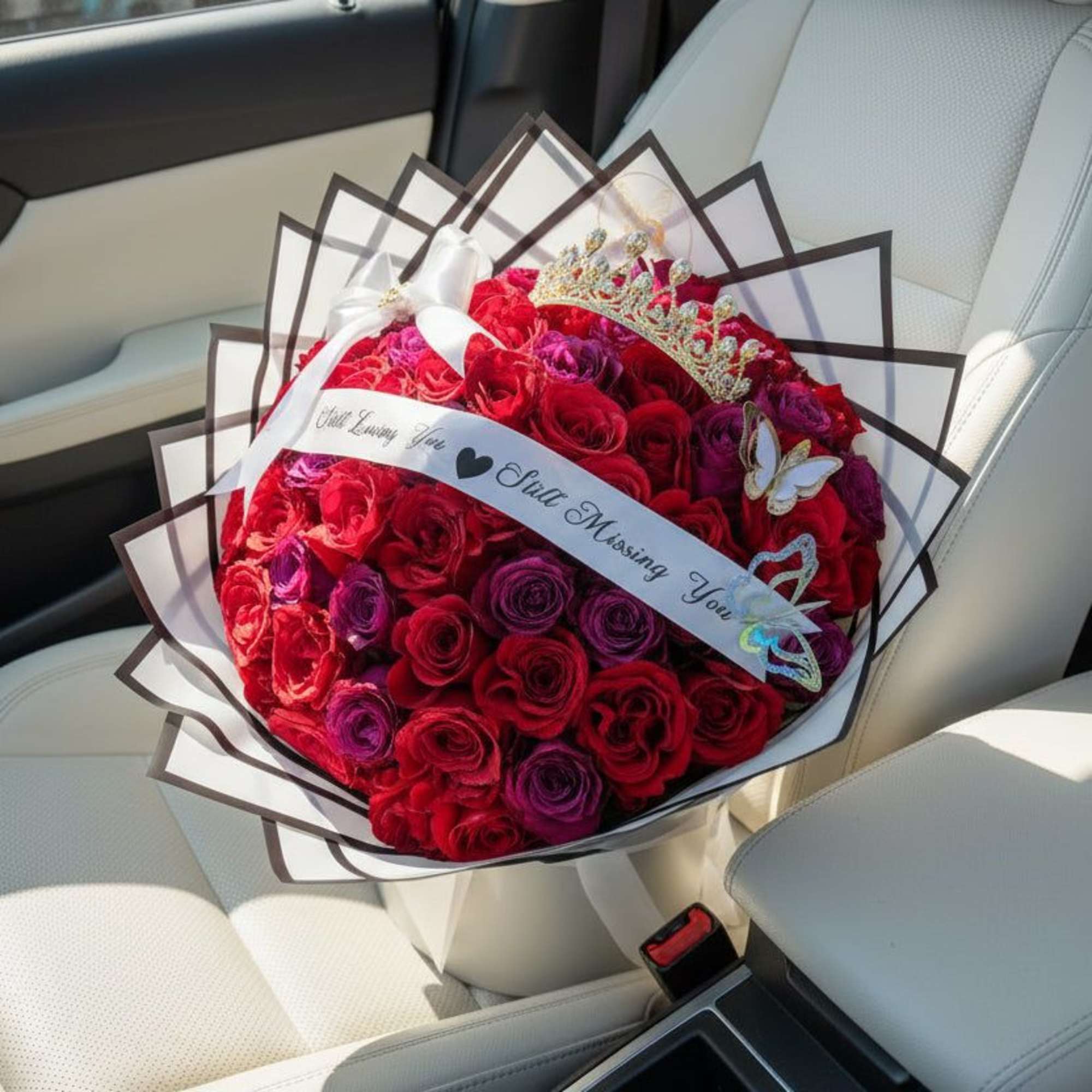 A stunning blend of red and purple roses wrapped in crisp white, photo 2 of 2